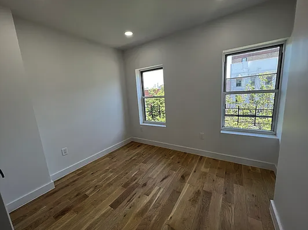 332 9th Street, Unit 4 Brooklyn, NY 11215 - Photo 2 of 8 an empty room with wooden floor and windows