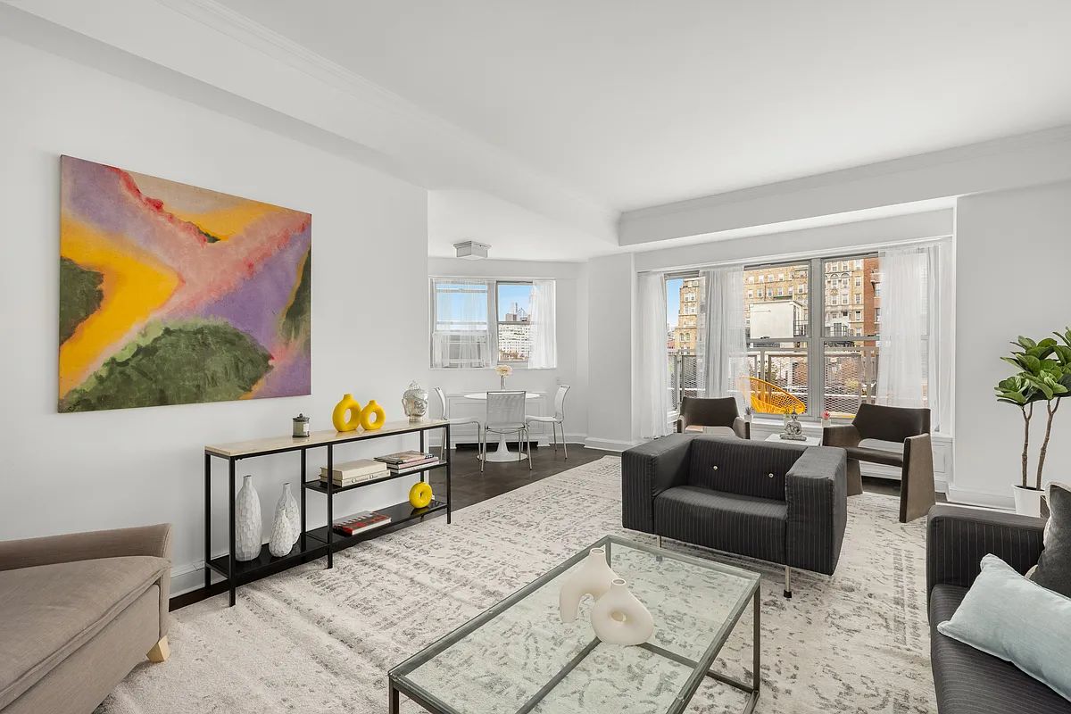 a living room with furniture a flat screen tv and a window