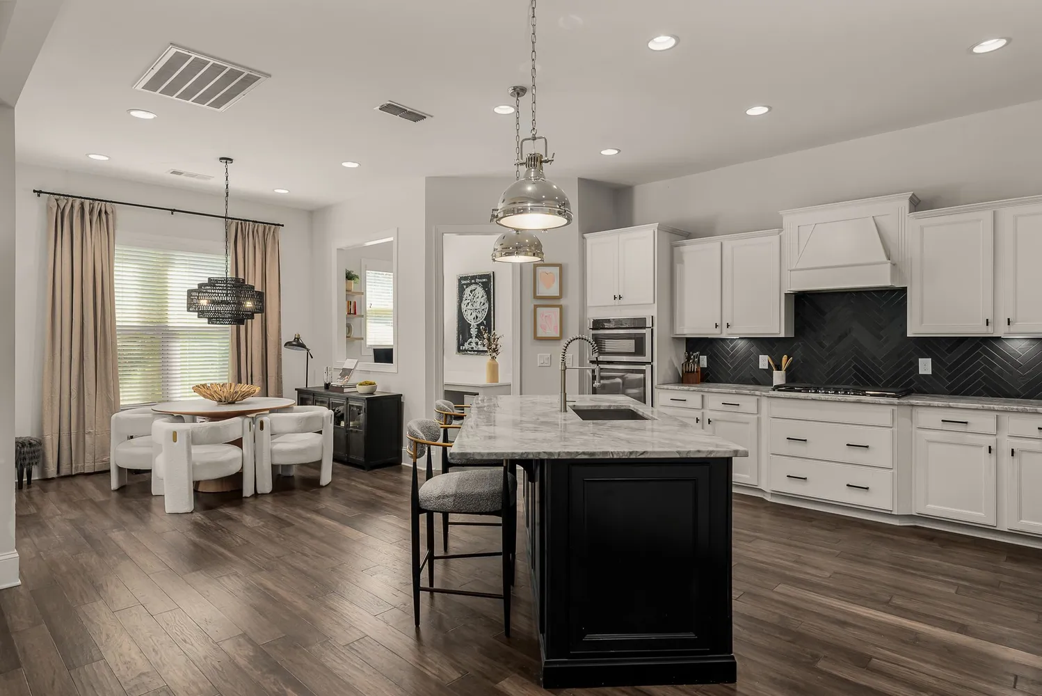 a view of a dining room with furniture a chandelier and wooden floor