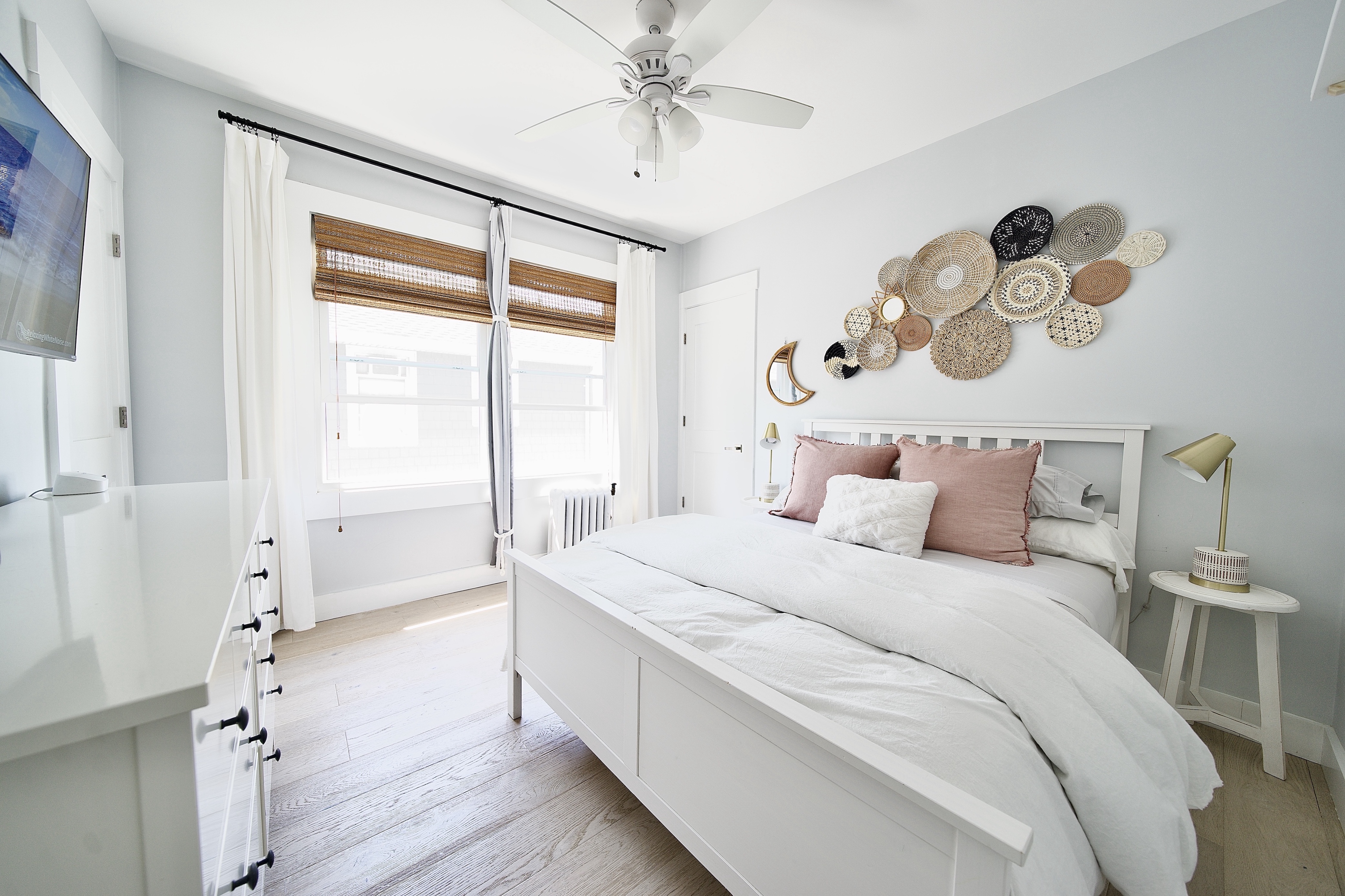 a spacious bedroom with a bed and a chandelier