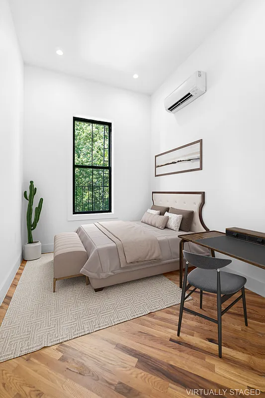 866 Bushwick Avenue, Unit 1 Brooklyn, NY 11221 - Photo 8 of 13 a bedroom with a bed and a window