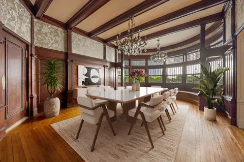 a view of a dining room with furniture window and wooden floor