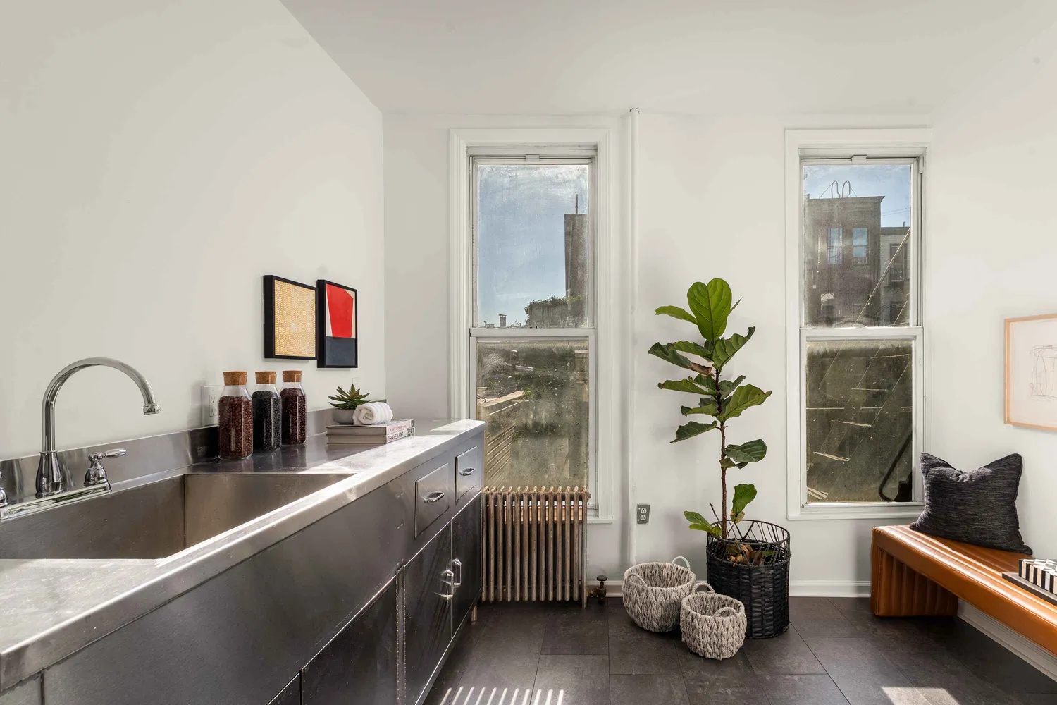 a kitchen with a sink and a potted plant