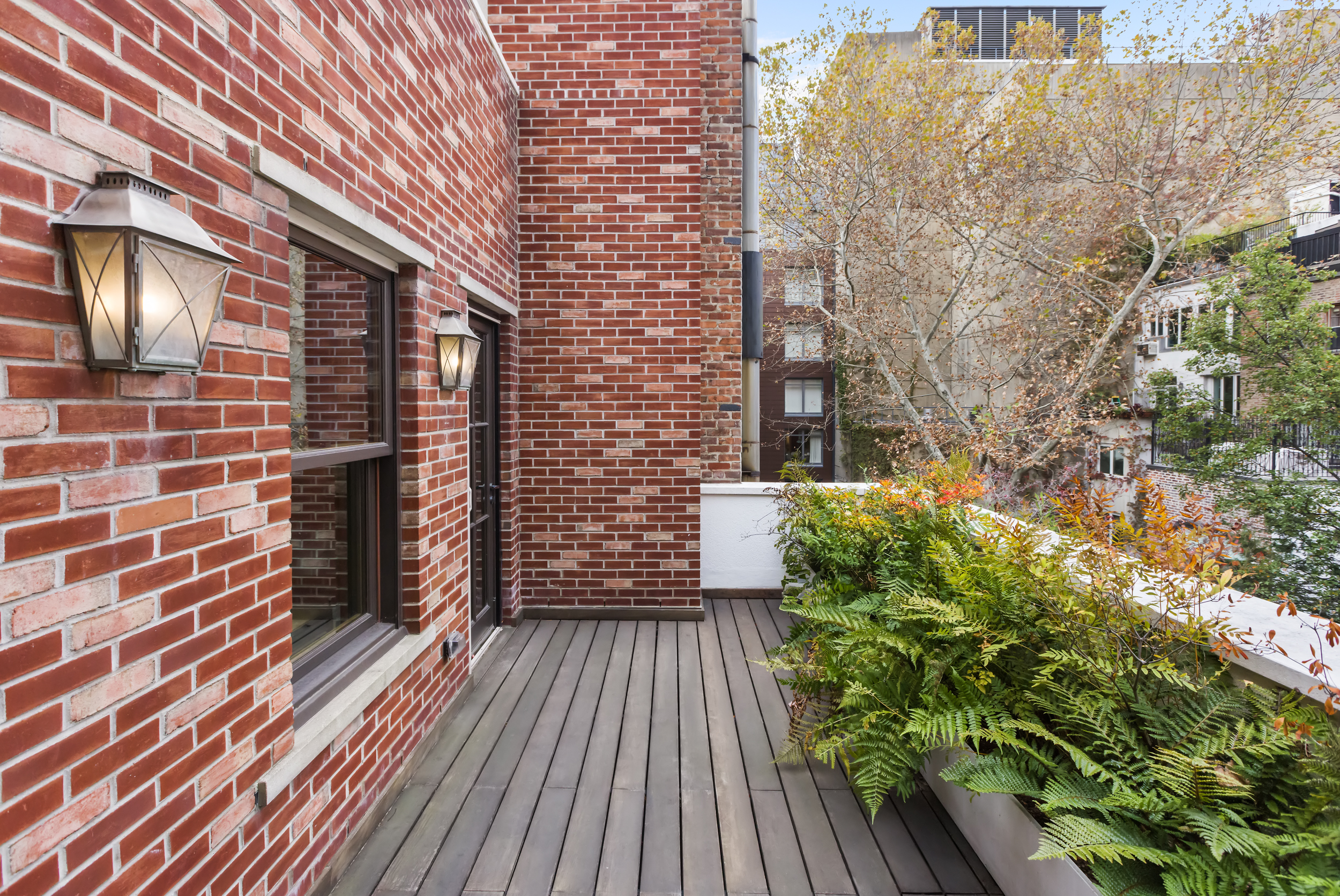 45 East 74th Street Manhattan, NY 10021 - Photo 26 of 33 a balcony with wooden floor and brick walls