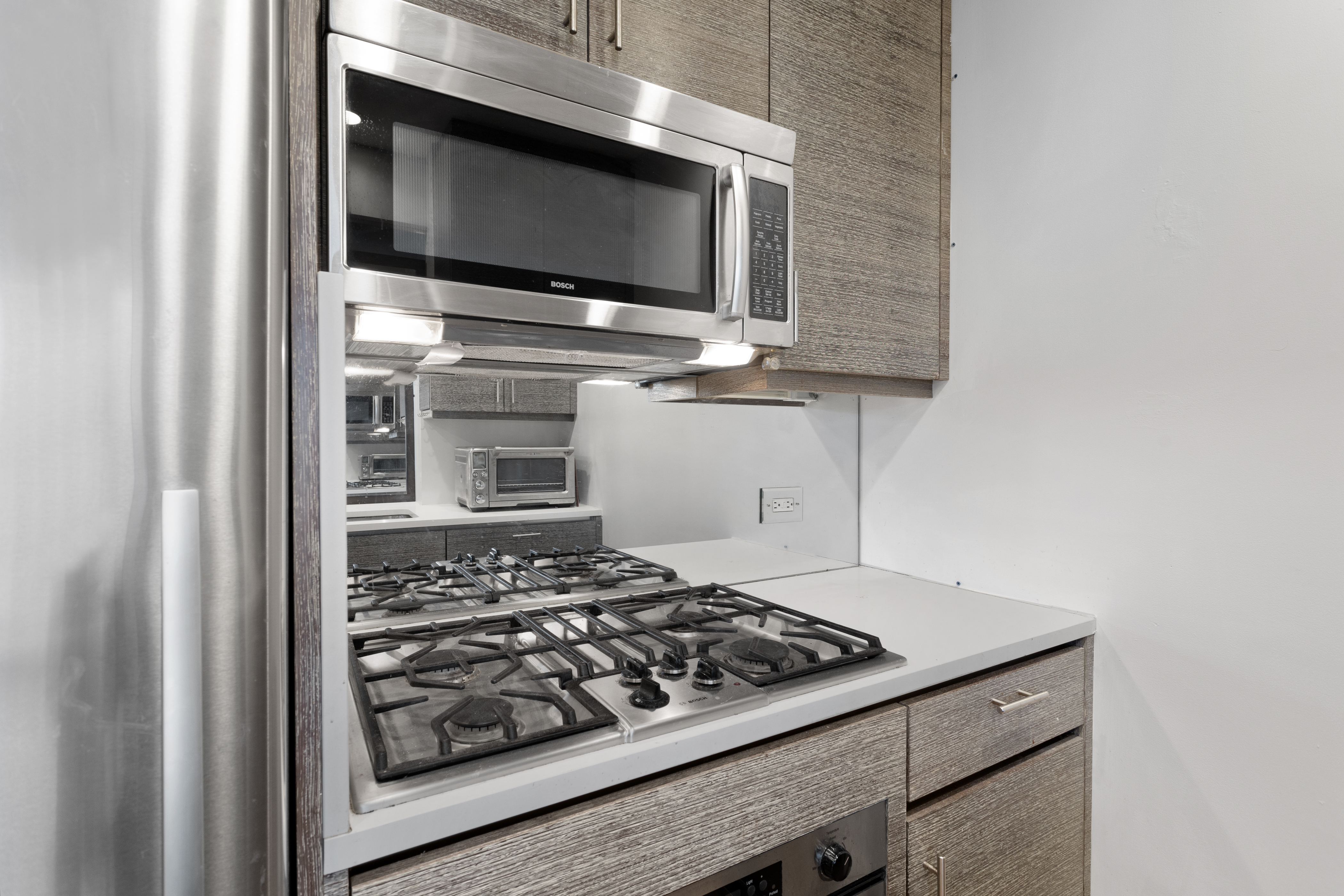 305 West 16th Street, Unit 5B Manhattan, NY 10011 - Photo 6 of 15 a kitchen with a stove and a microwave