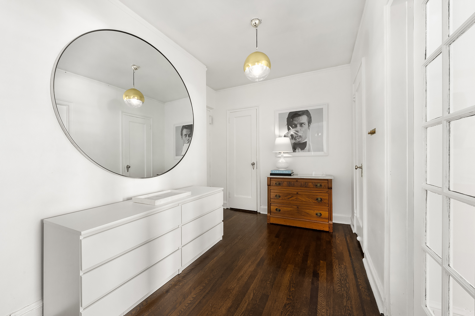 166 West 22nd Street, Unit 6C Manhattan, NY 10011 - Photo 3 of 11 an entryway with wooden floor and mirror