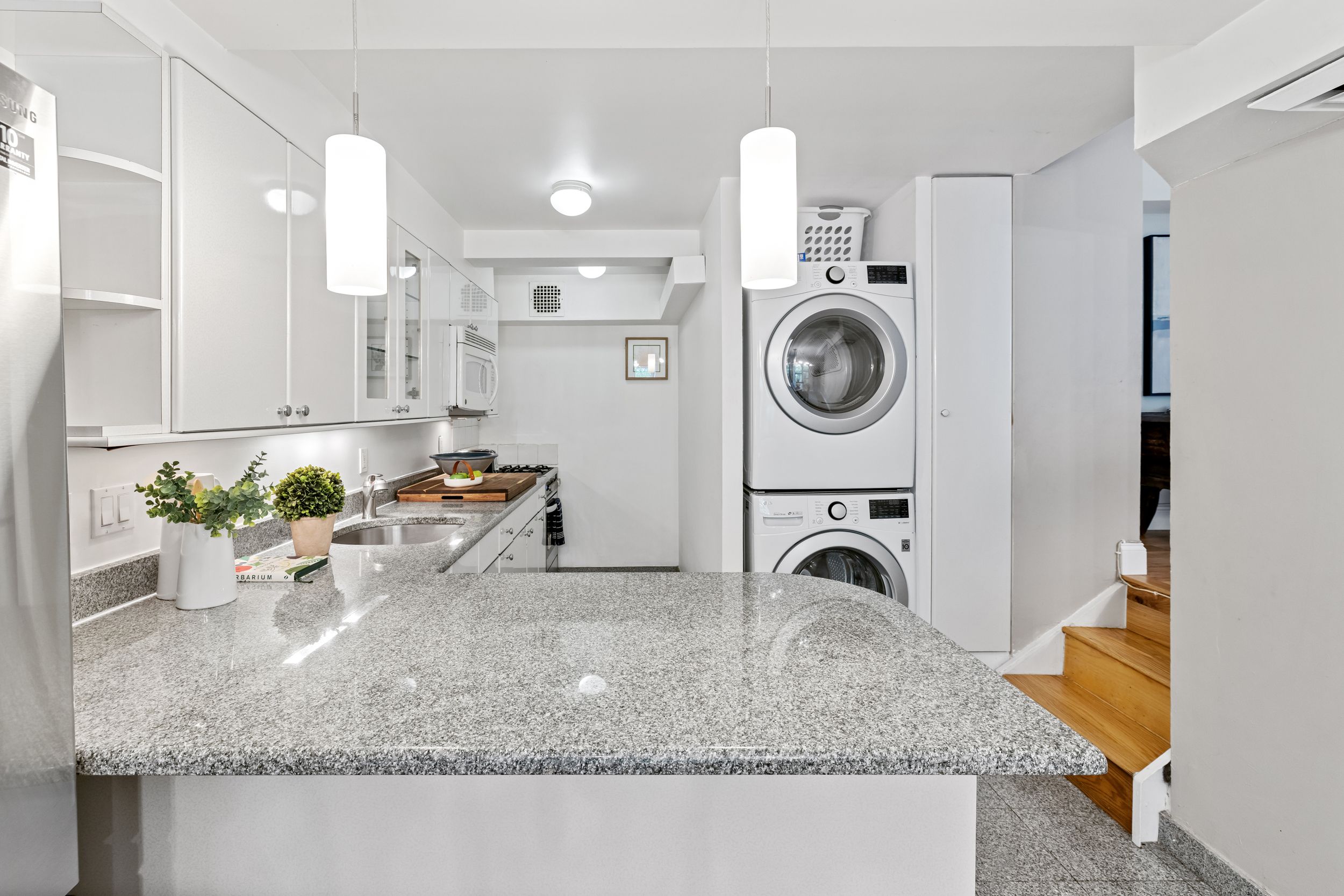 248 East 31st Street, Unit 4A Manhattan, NY 10016 - Photo 5 of 14 a bathroom with granite countertop a sink and a mirror