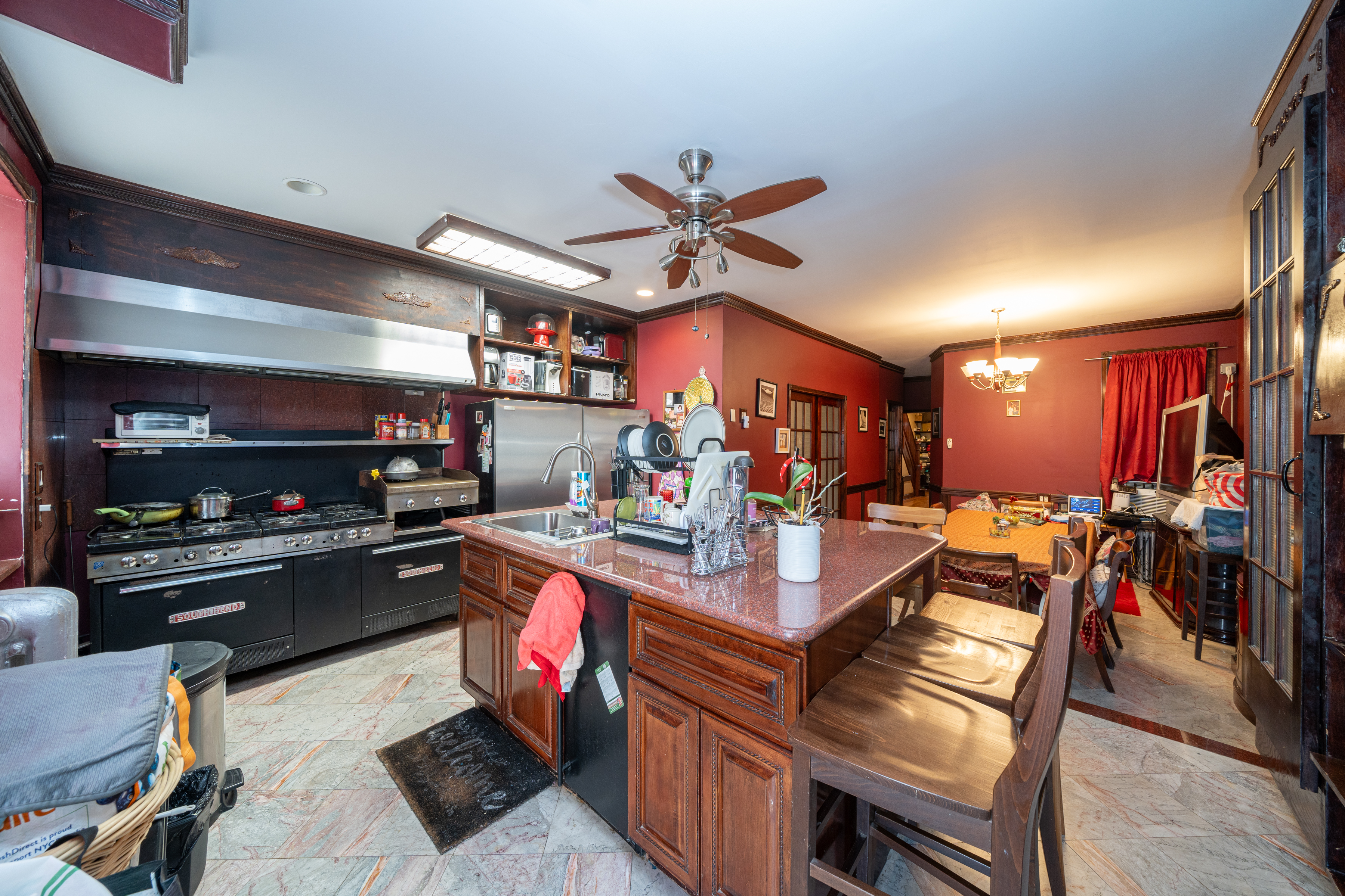 415 84th Street Brooklyn, NY 11209 - Photo 7 of 17 a kitchen with stainless steel appliances granite countertop a stove and a refrigerator