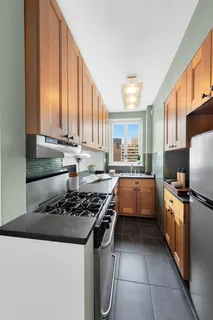 a kitchen with stainless steel appliances a stove a sink and a refrigerator