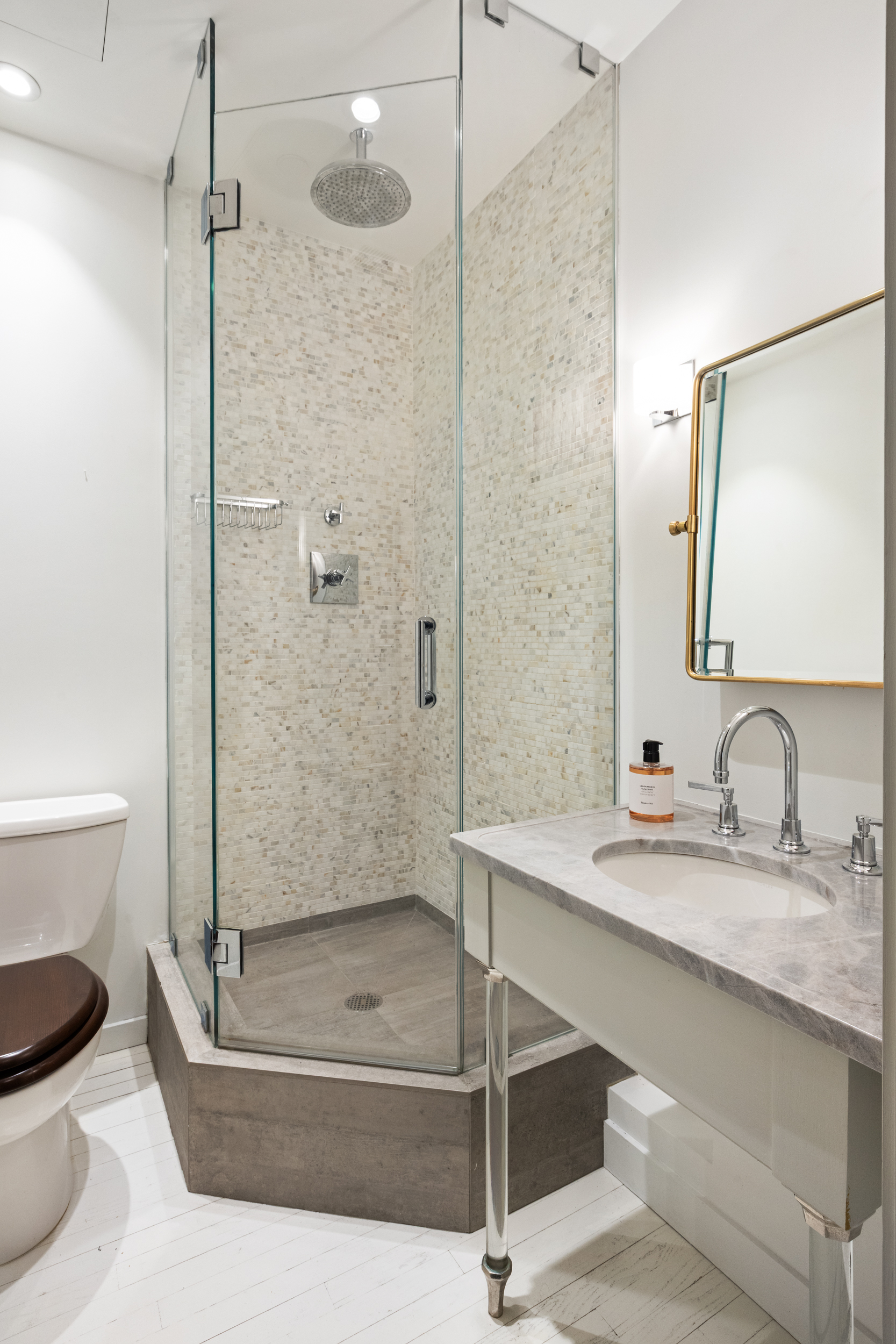 32 West 20th Street, Unit 5 Manhattan, NY 10011 - Photo 17 of 18 a bathroom with a granite countertop sink toilet and shower