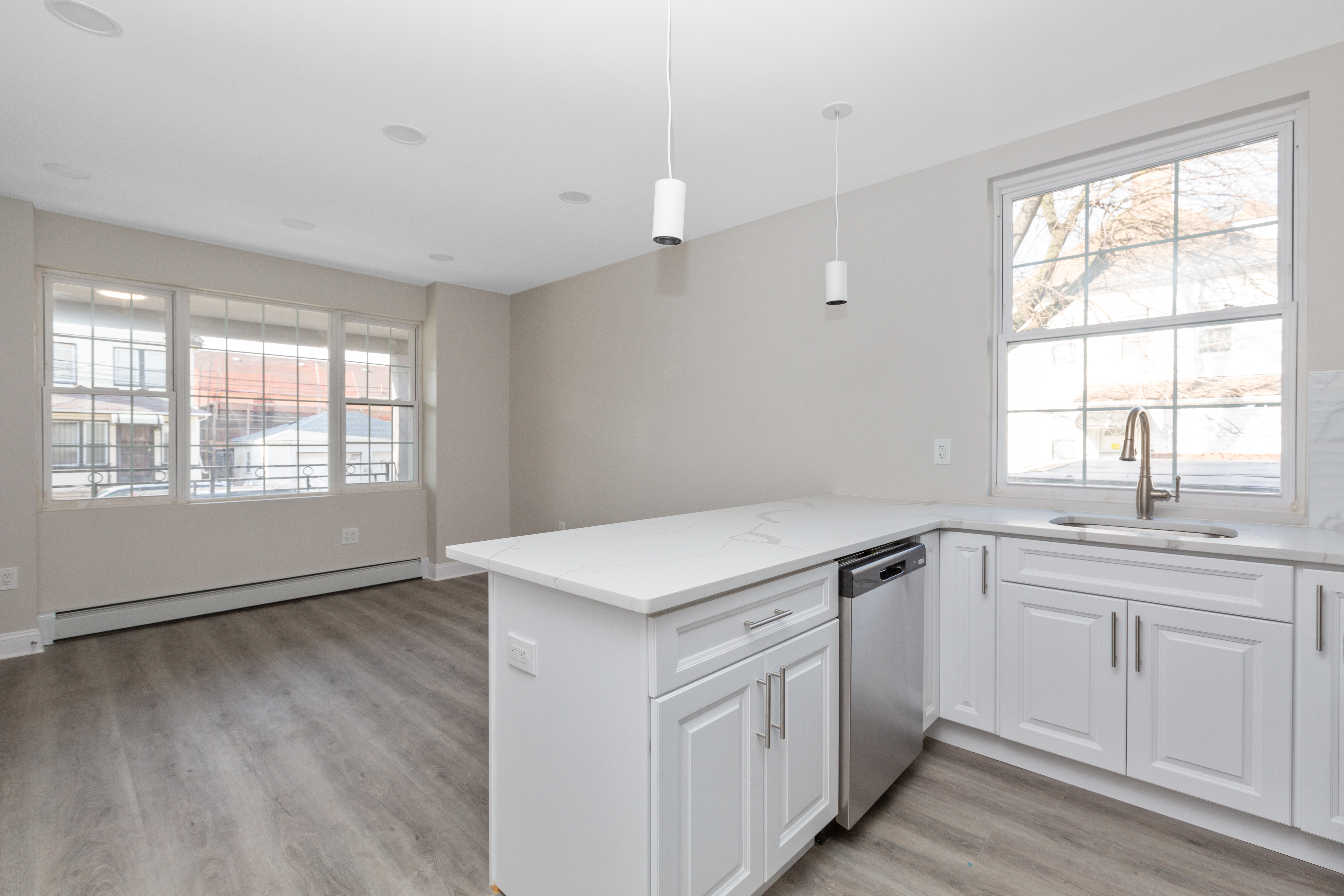 143-10 Shore Avenue Queens, NY 11435 - Photo 19 of 30 a kitchen with granite countertop white cabinets and white appliances