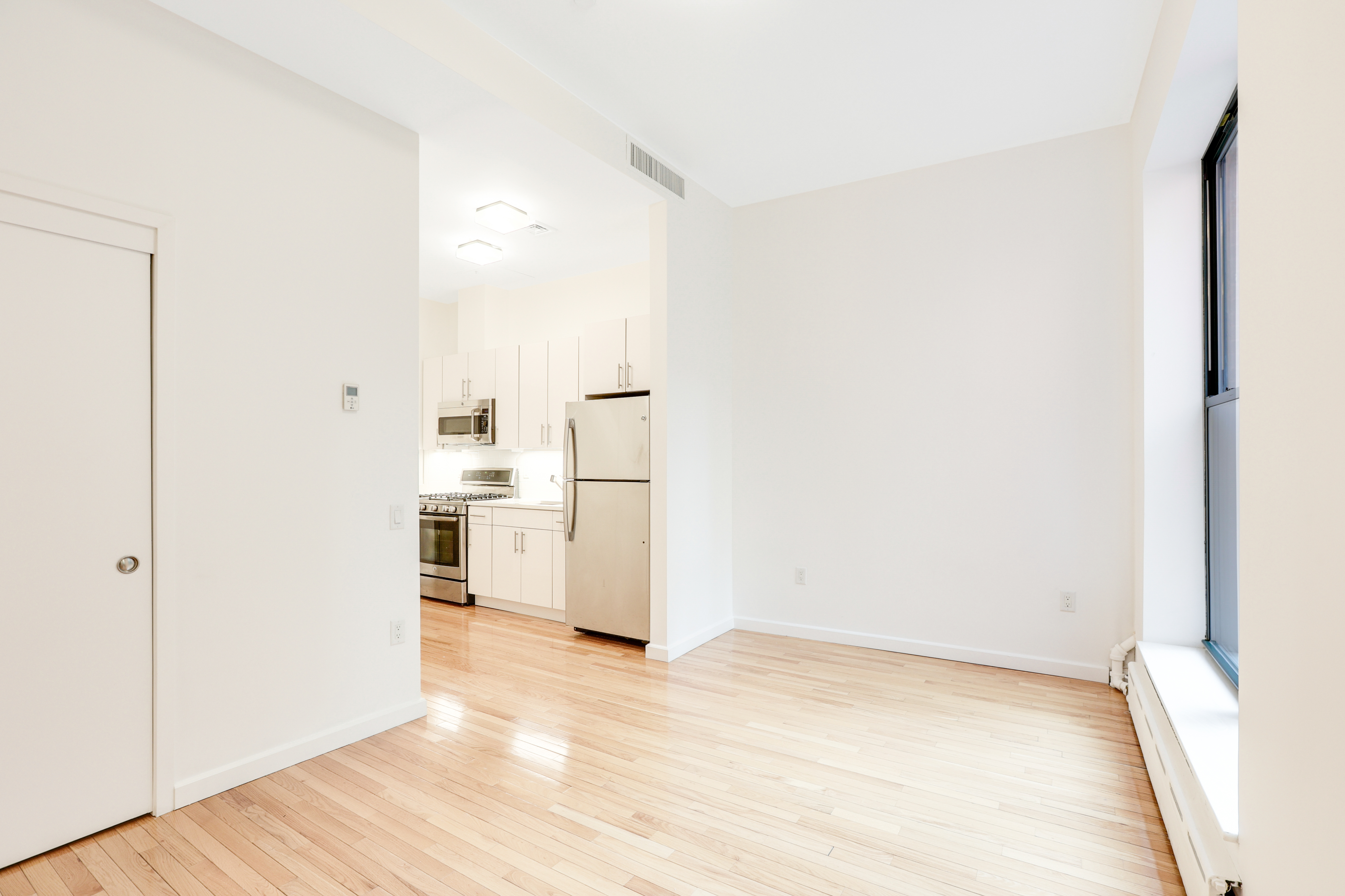 230 West 75th Street, Unit 1 Manhattan, NY 10023 - Photo 5 of 9 a view of a kitchen with wooden floor