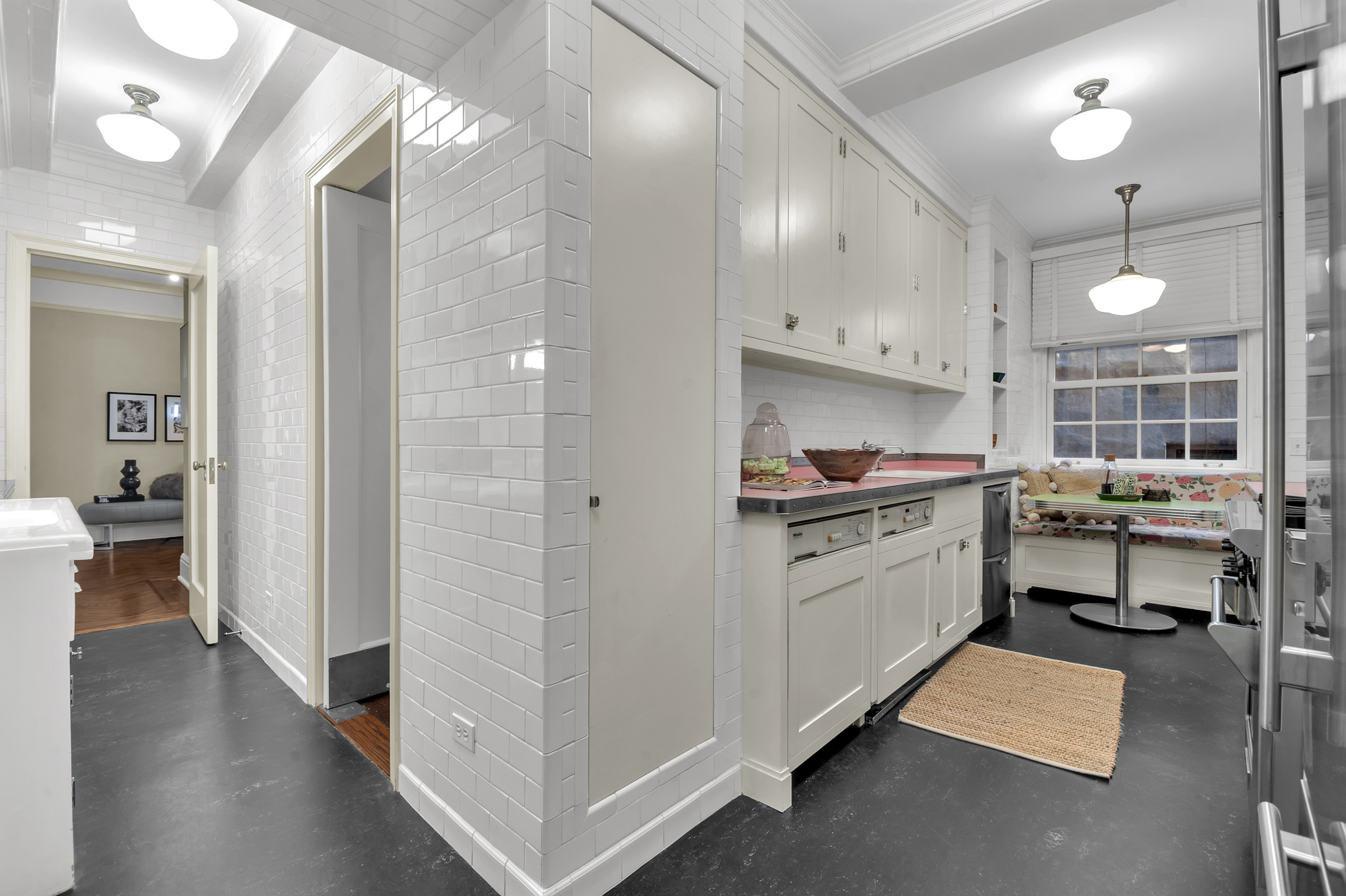 7 Gracie Square, Unit 5A Manhattan, NY 10128 - Photo 17 of 26 a kitchen with sink cabinets and stove