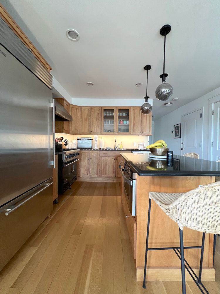 148 Luquer Street, Unit 2 Brooklyn, NY 11231 - Photo 7 of 22 a kitchen with stainless steel appliances granite countertop a stove top oven a sink dishwasher a dining table and chairs with wooden floor