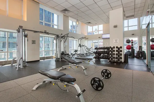 a room with gym equipment and view of living room
