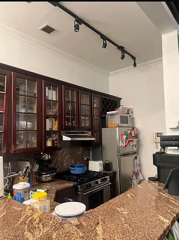 a kitchen with a refrigerator and a stove