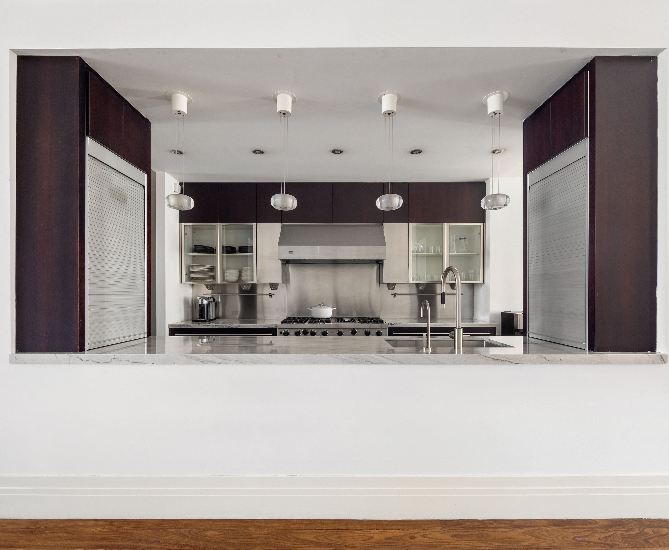 27 North Moore Street, Unit 10D Manhattan, NY 10013 - Photo 13 of 30 a view of a kitchen with stainless steel appliances granite countertop a refrigerator a sink and a stove