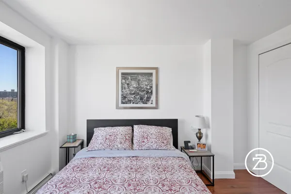 a bedroom with a bed and a lamp on table