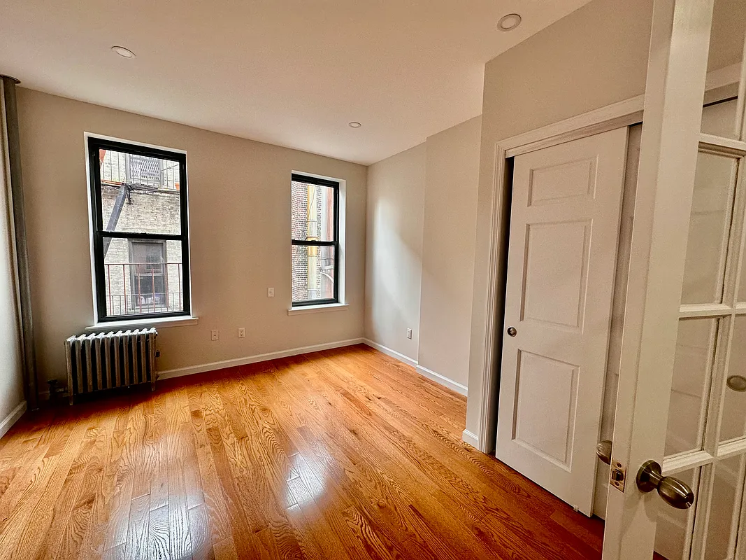 22 St Marks Place, Unit 16 Manhattan, NY 10003 - Photo 1 of 5 an empty room with wooden floor and windows