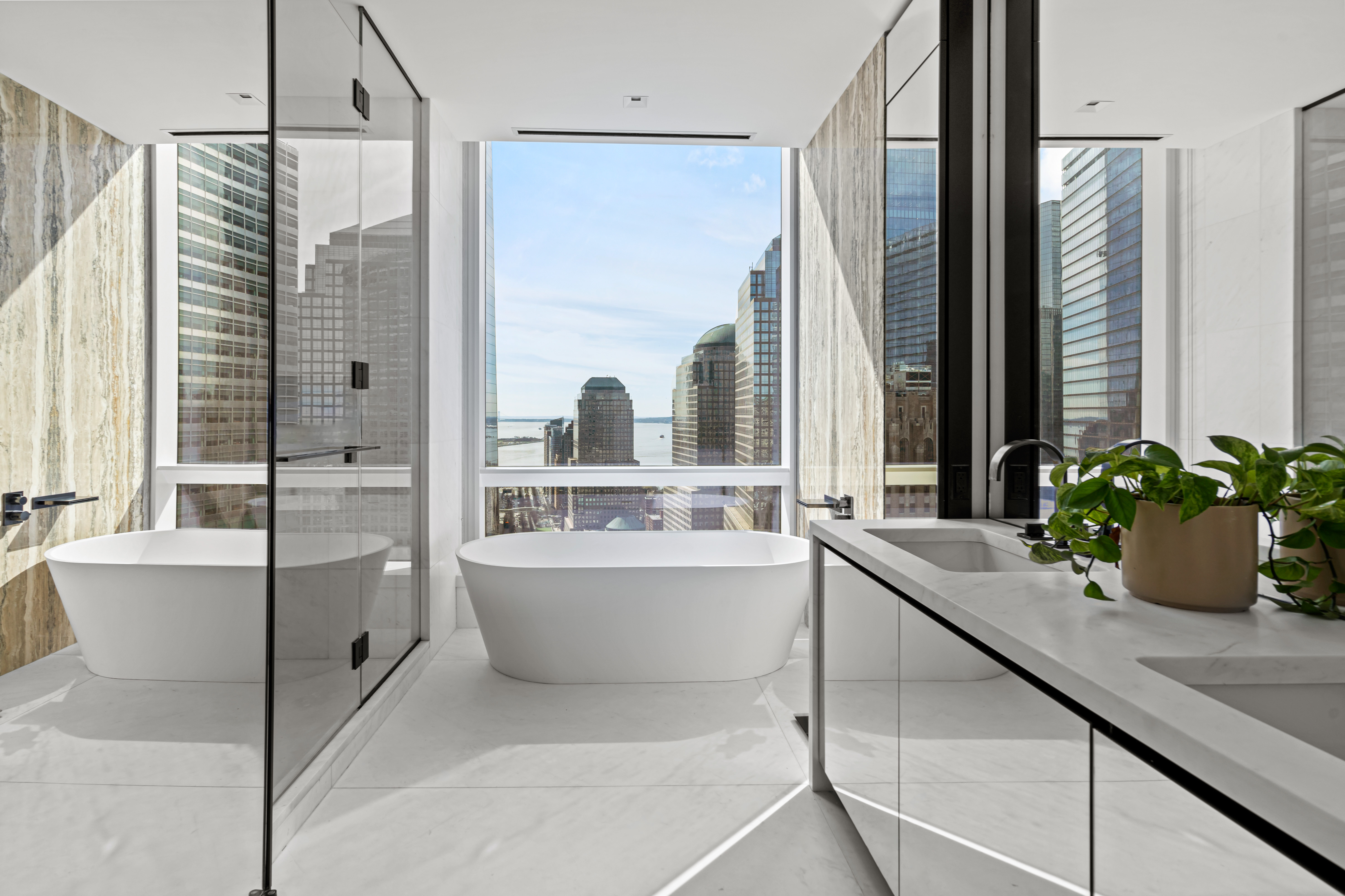 111 Murray Street, Unit 43B Manhattan, NY 10007 - Photo 6 of 17 a bathroom with a tub sink and mirror