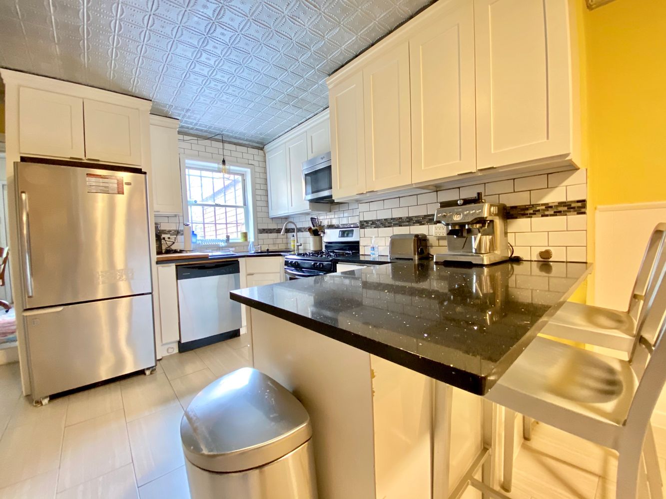 390 5th Street, Unit 1 Brooklyn, NY 11215 - Photo 10 of 15 a kitchen with stainless steel appliances granite countertop a sink a refrigerator and a stove