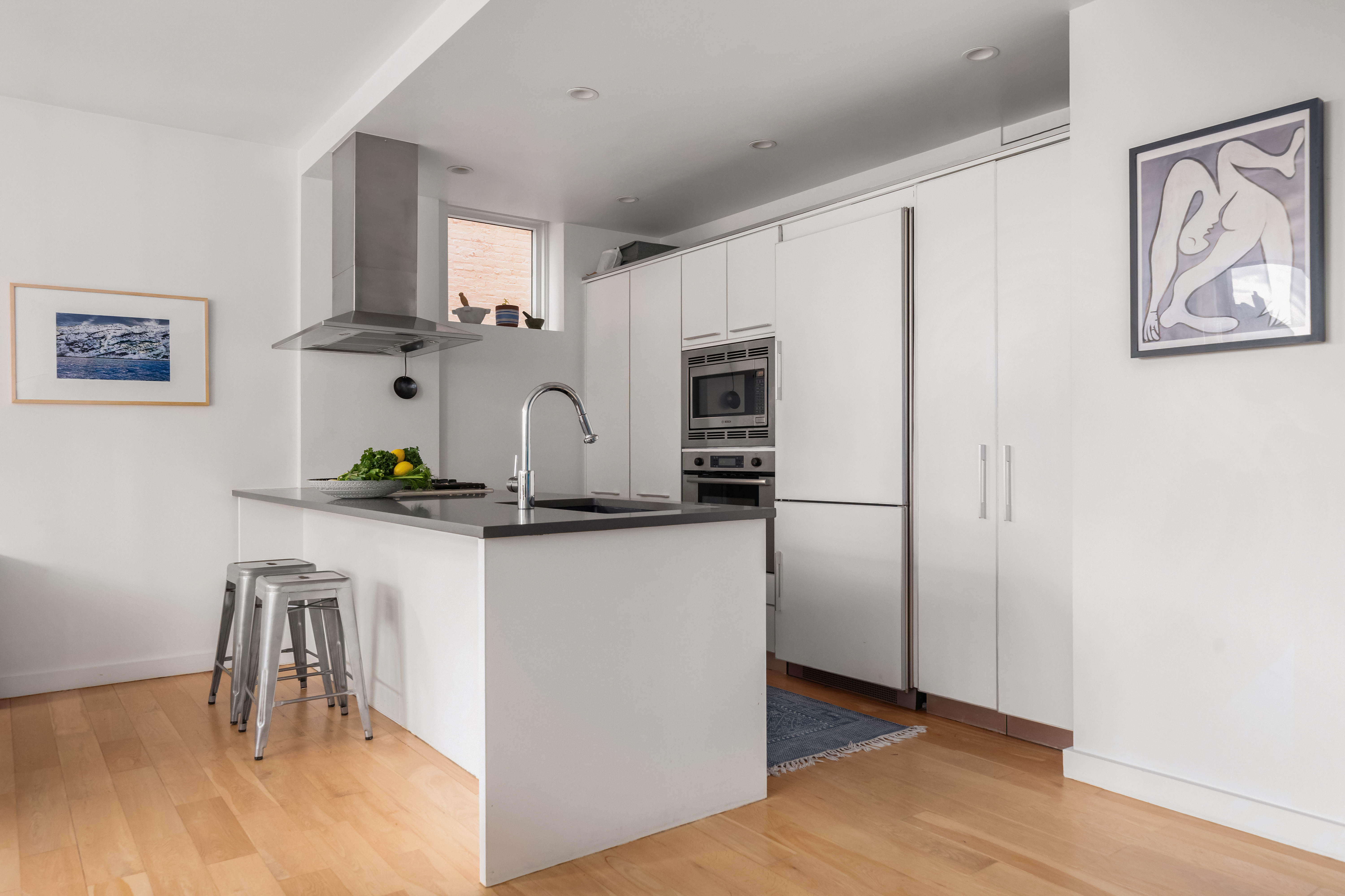 70 Berry Street, Unit 5G Brooklyn, NY 11249 - Photo 4 of 10 a kitchen with stainless steel appliances white cabinets and a refrigerator