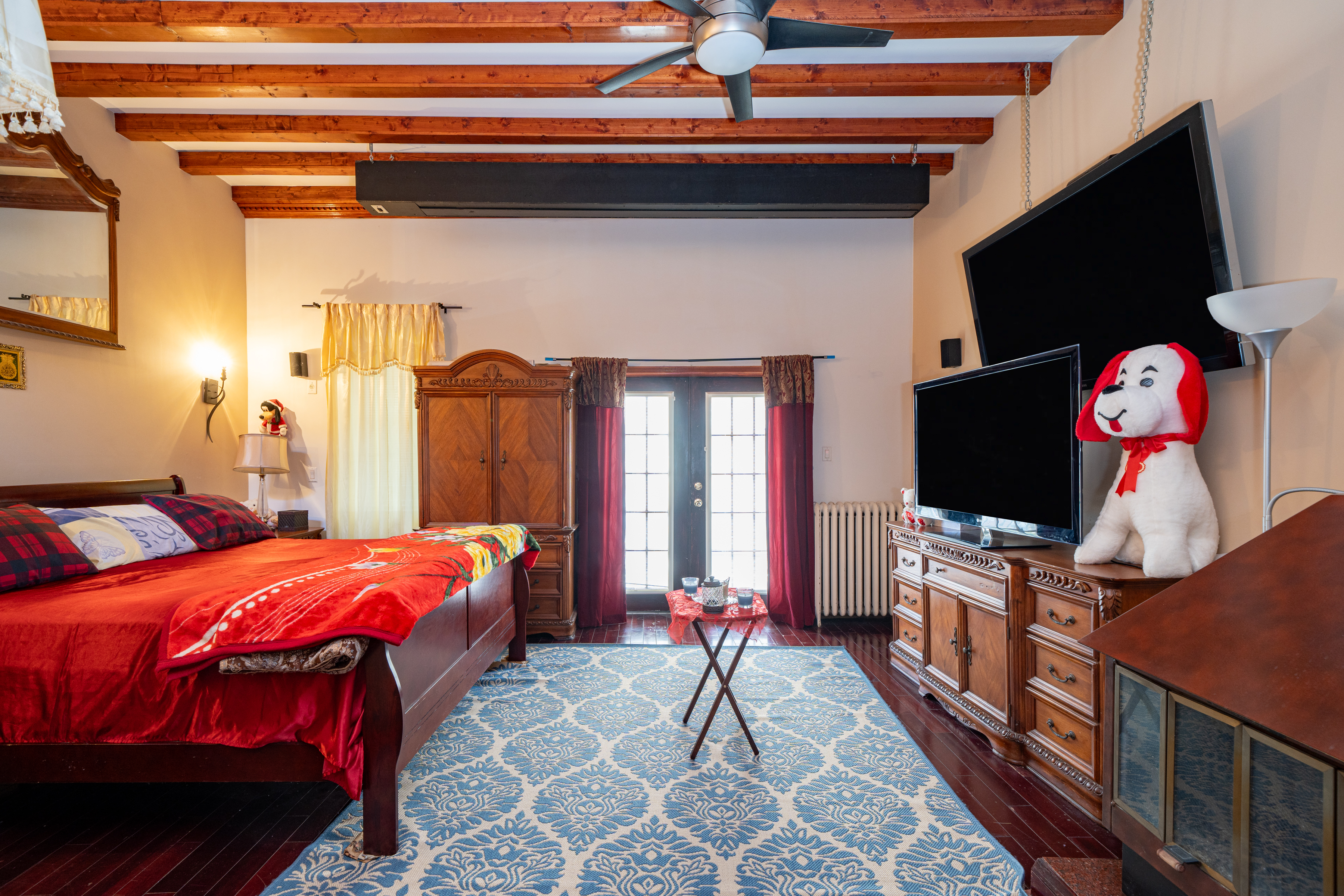 415 84th Street Brooklyn, NY 11209 - Photo 10 of 17 a bedroom with a bed and a flat screen tv