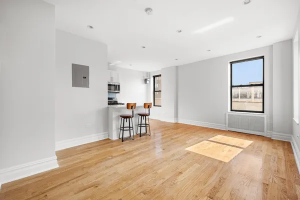 a view of a livingroom with furniture and a window