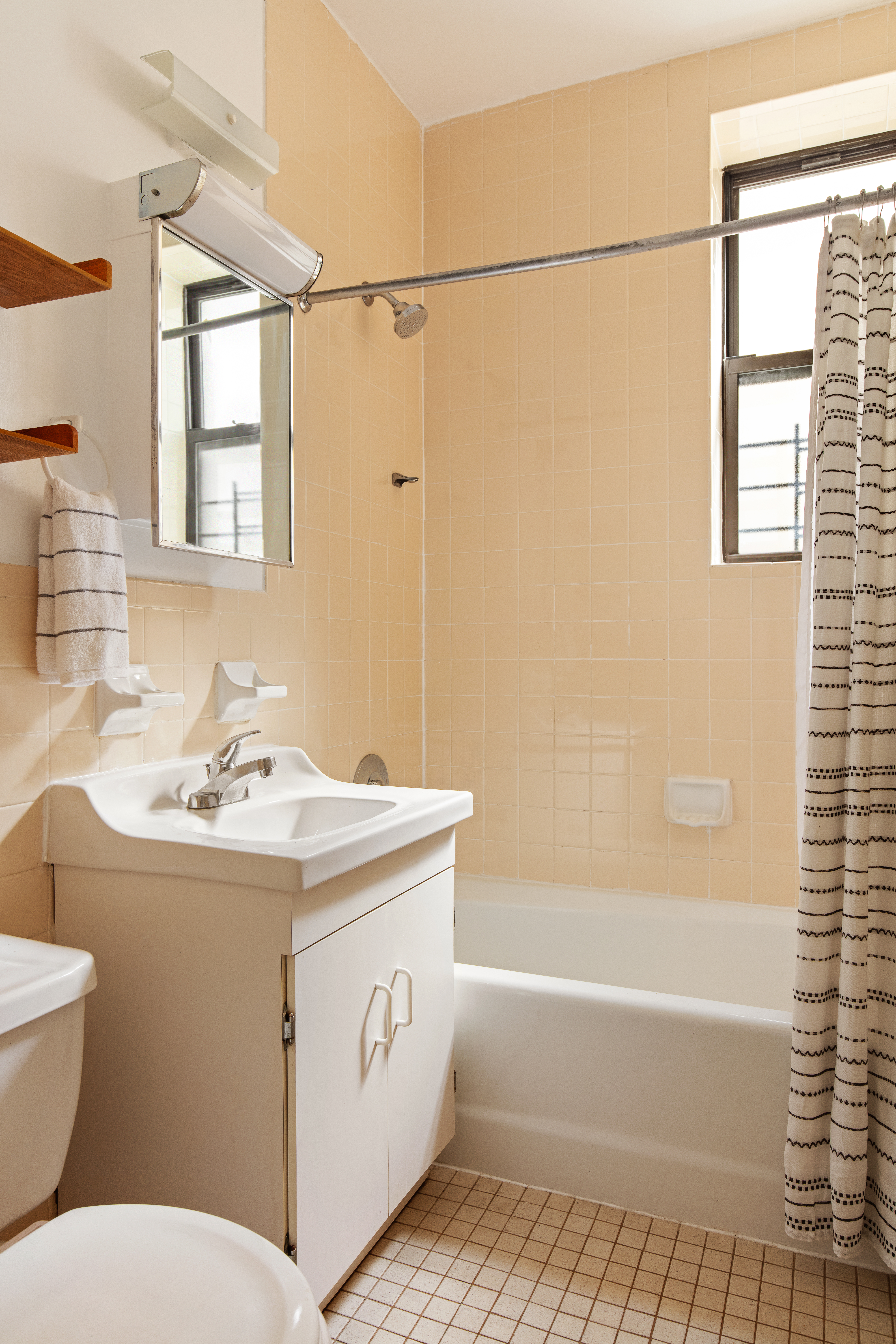 242 West 112th Street, Unit 5B Manhattan, NY 10026 - Photo 5 of 9 a bathroom with a sink a toilet and shower