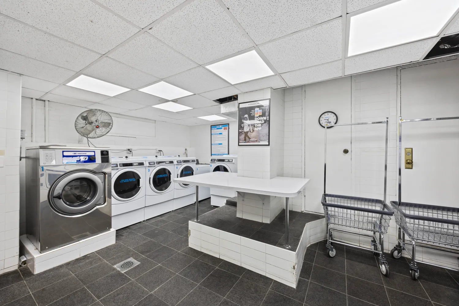 a view of a storage and utility room with washer and dryer