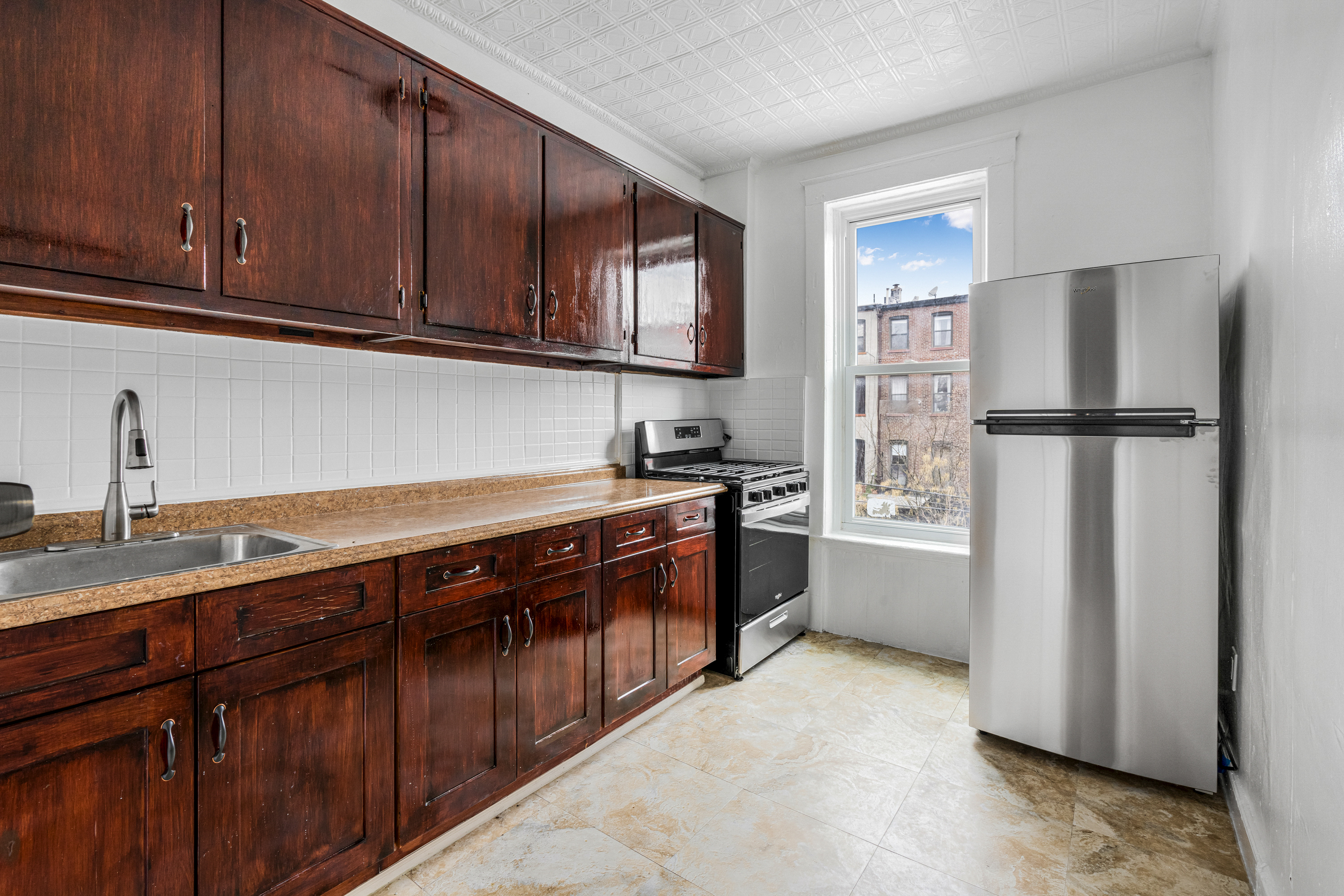 601 Jefferson Avenue, Unit 2 Brooklyn, NY 11221 - Photo 6 of 8 a kitchen with stainless steel appliances granite countertop a refrigerator sink and cabinets