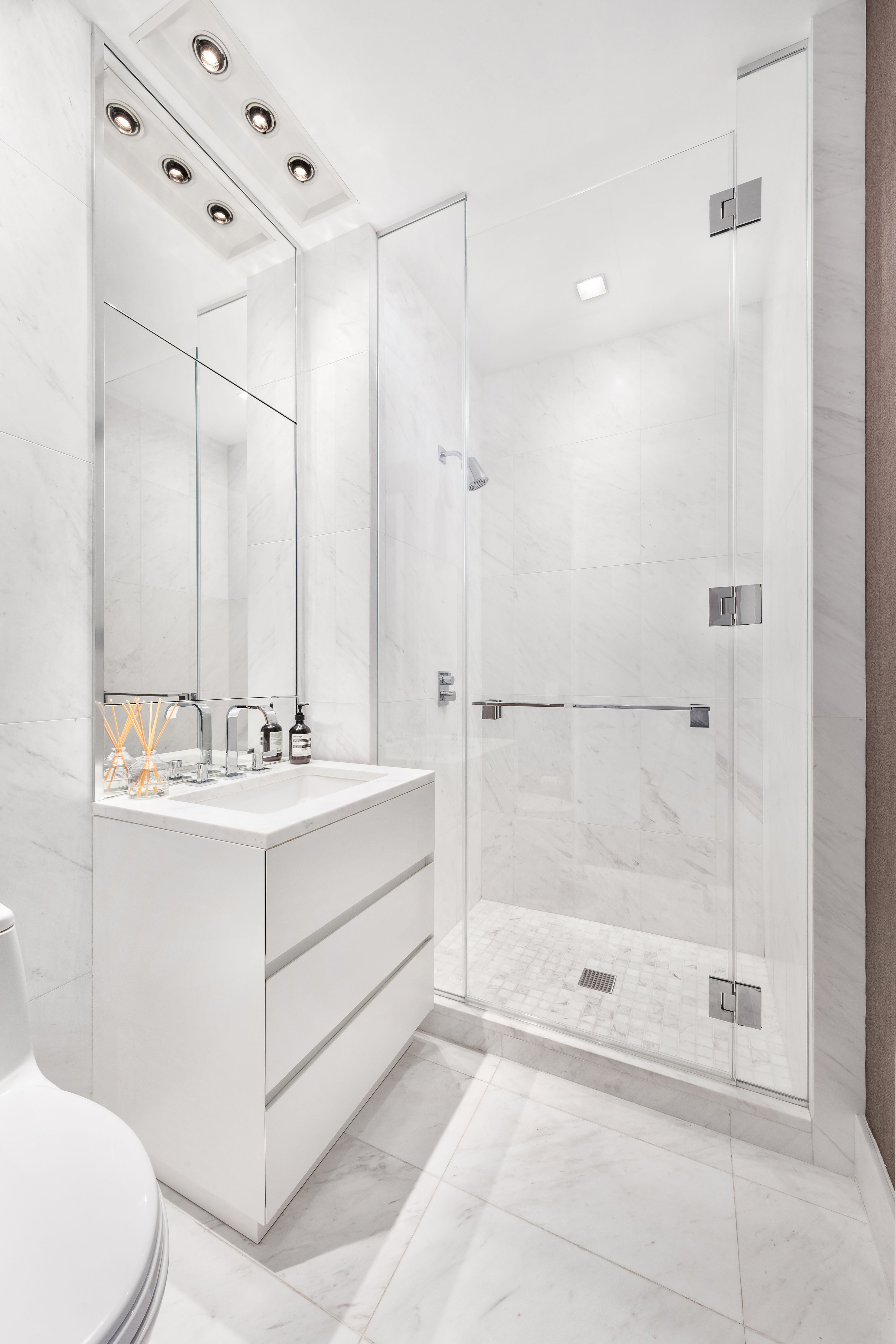111 Murray Street, Unit 35A Manhattan, NY 10007 - Photo 18 of 38 a bathroom with a bathtub shower sink and toilet