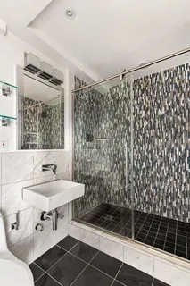 a bathroom with a sink toilet and shower