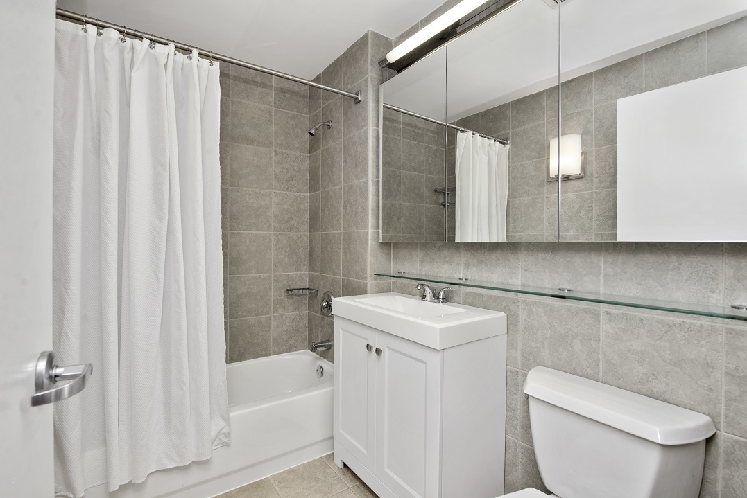 80 John Street, Unit 5G Manhattan, NY 10038 - Photo 6 of 8 a bathroom with a toilet a sink and bathtub
