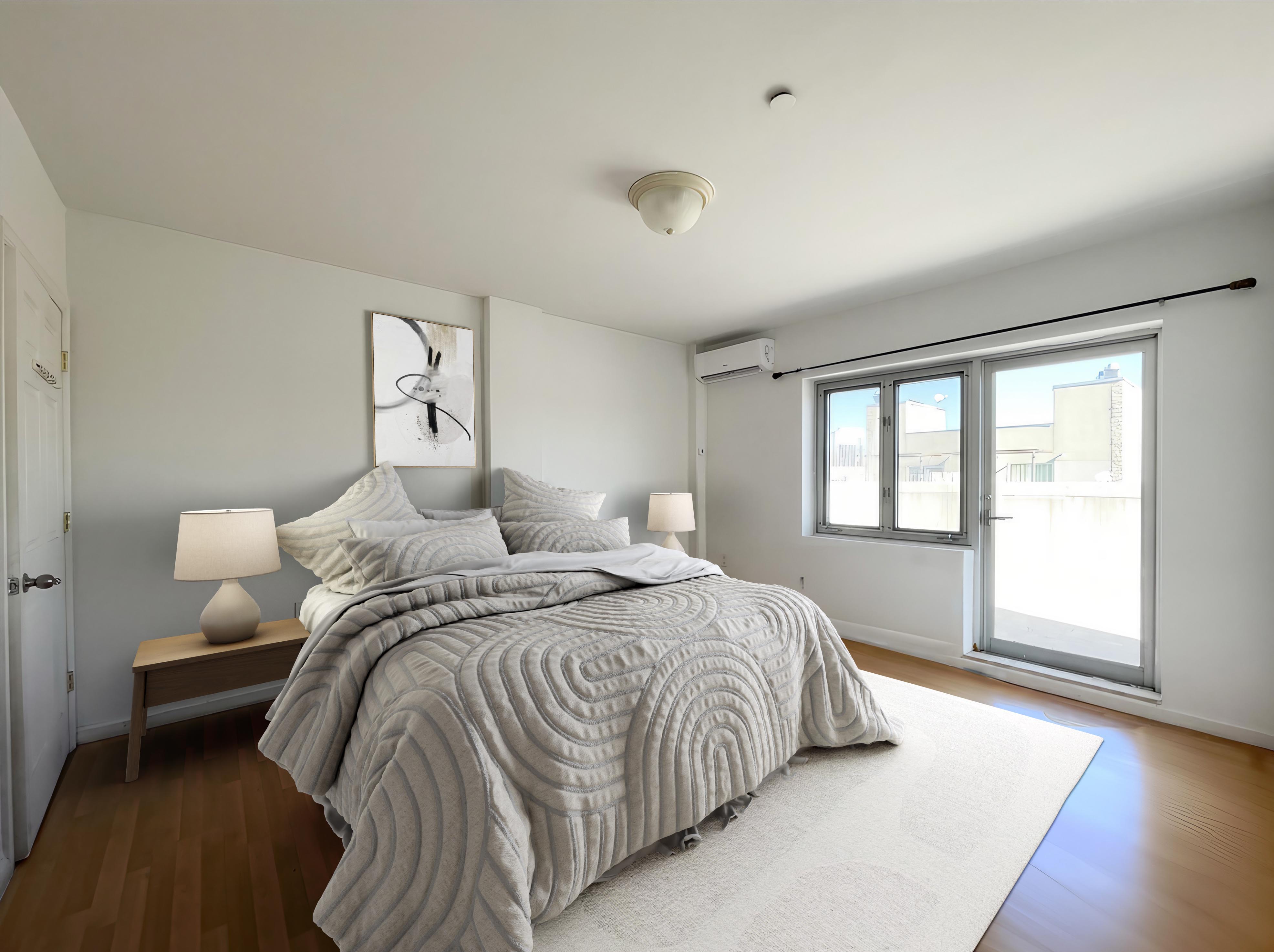 a bedroom with a bed and a large window