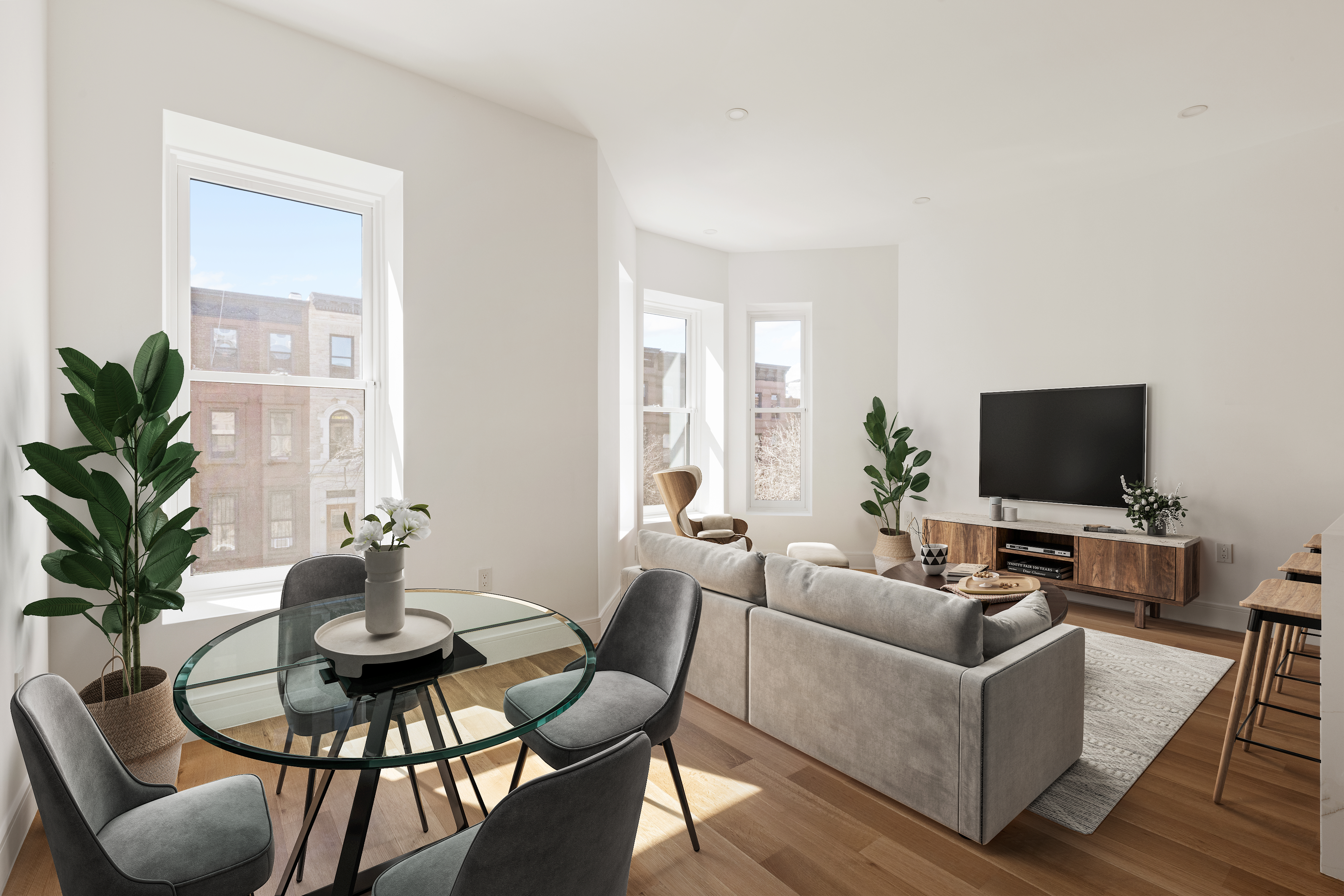 a living room with furniture a flat screen tv and a potted plant