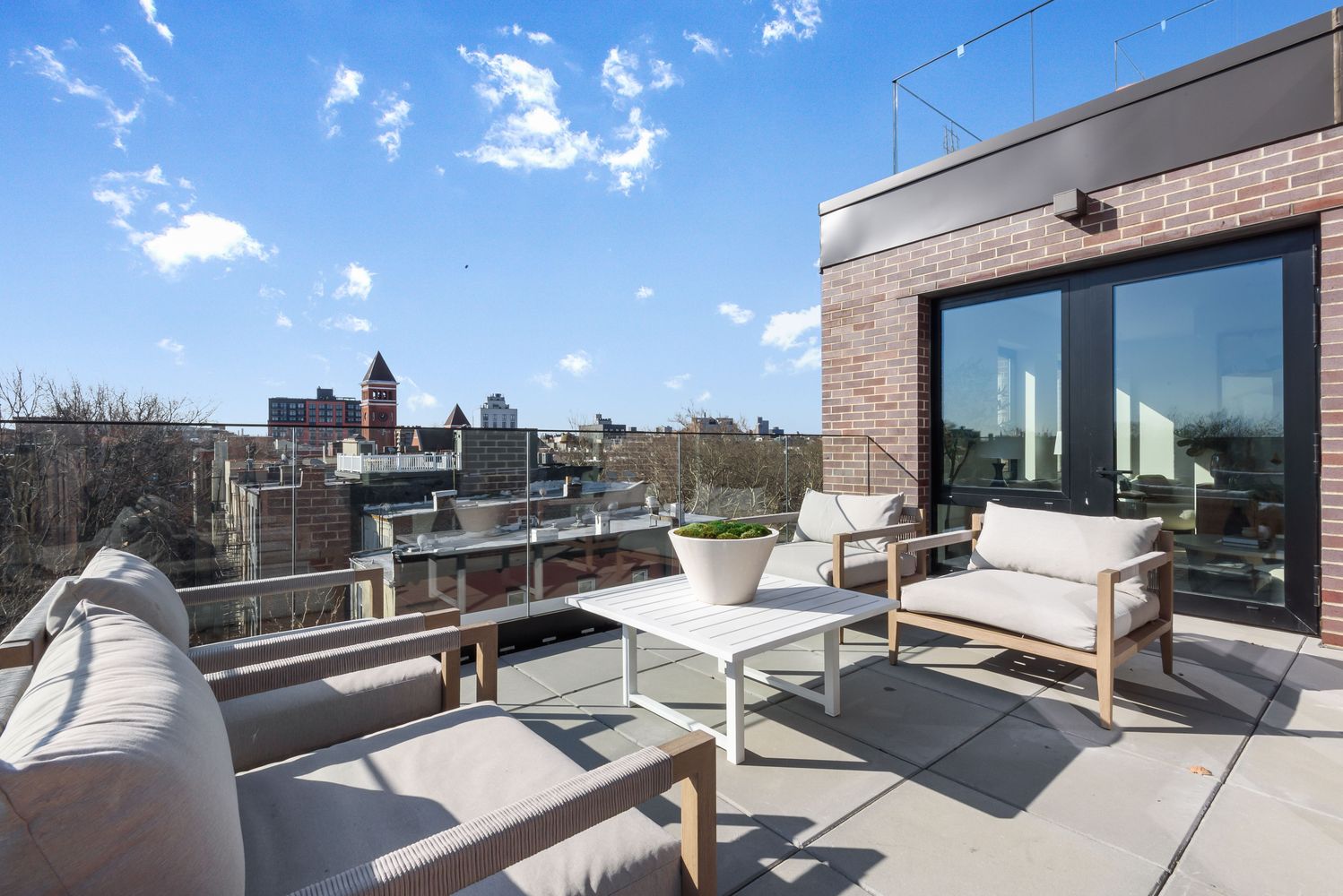 a view of a terrace with furniture and a potted plant