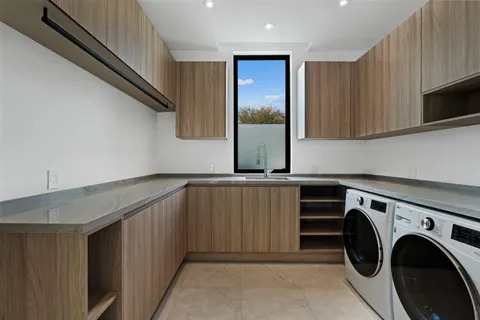 a utility room with sink dryer and washer