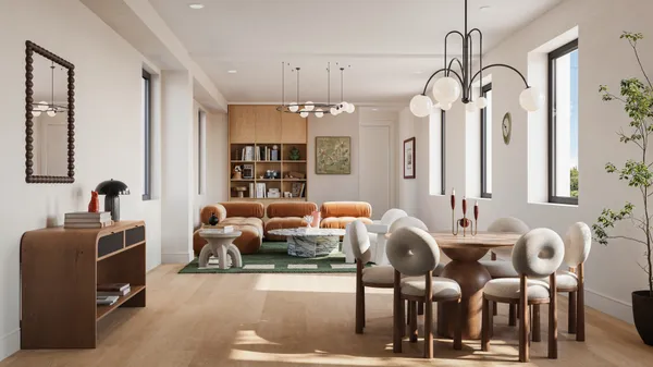 a living room with furniture flowers and wooden floor