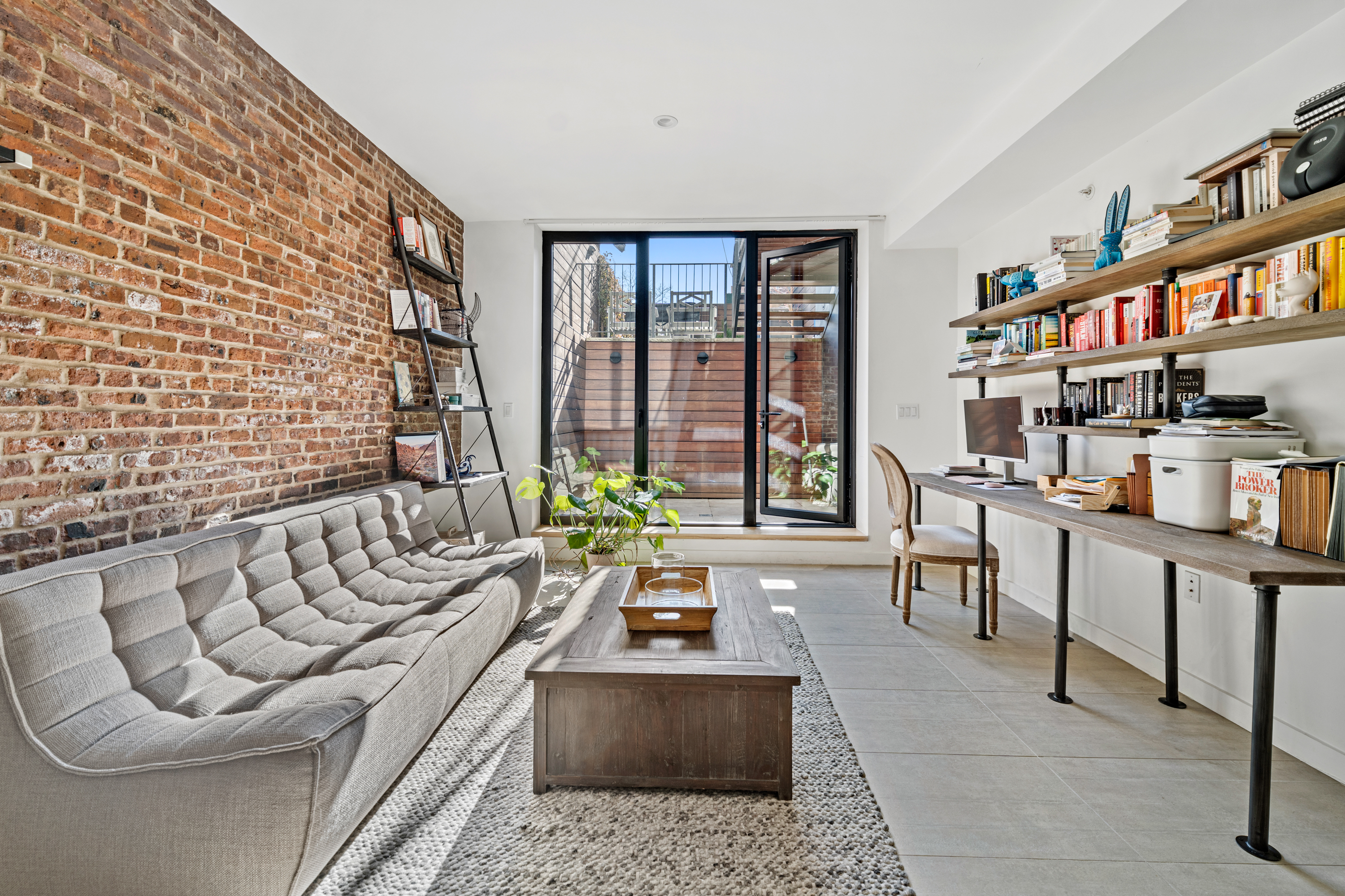 88 Lexington Avenue, Unit 1A Brooklyn, NY 11238 - Photo 9 of 13 a living room with furniture and a floor to ceiling window