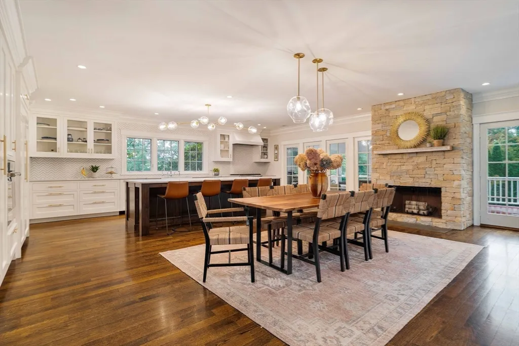 a dining room with furniture a fireplace and wooden floor