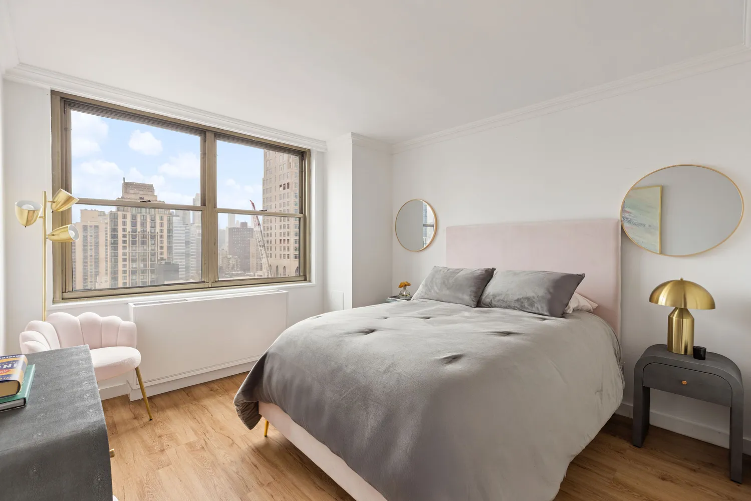 a bed sitting in a bedroom next to a window