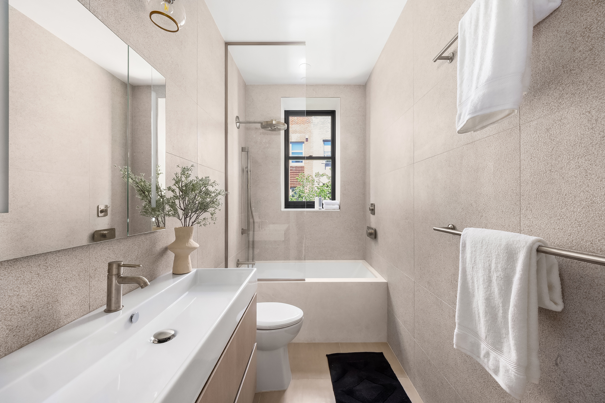 53 West 85th Street Manhattan, NY 10024 - Photo 29 of 37 a bathroom with a sink a toilet a tub and shower