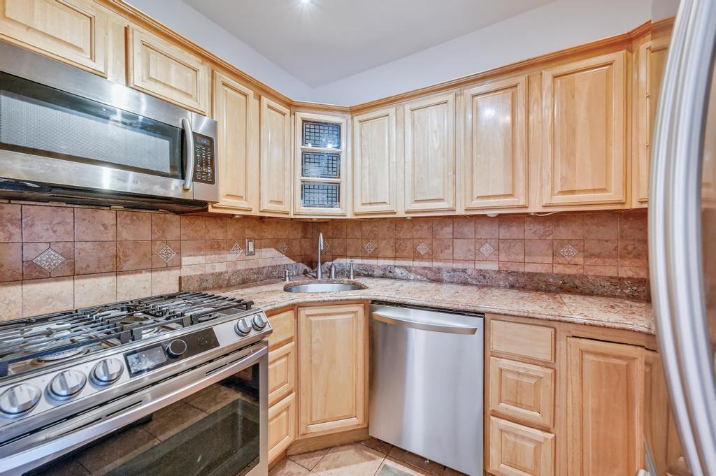 57 Carroll Street, Unit 38A Brooklyn, NY 11231 - Photo 15 of 21 a kitchen with stainless steel appliances granite countertop a stove and a microwave