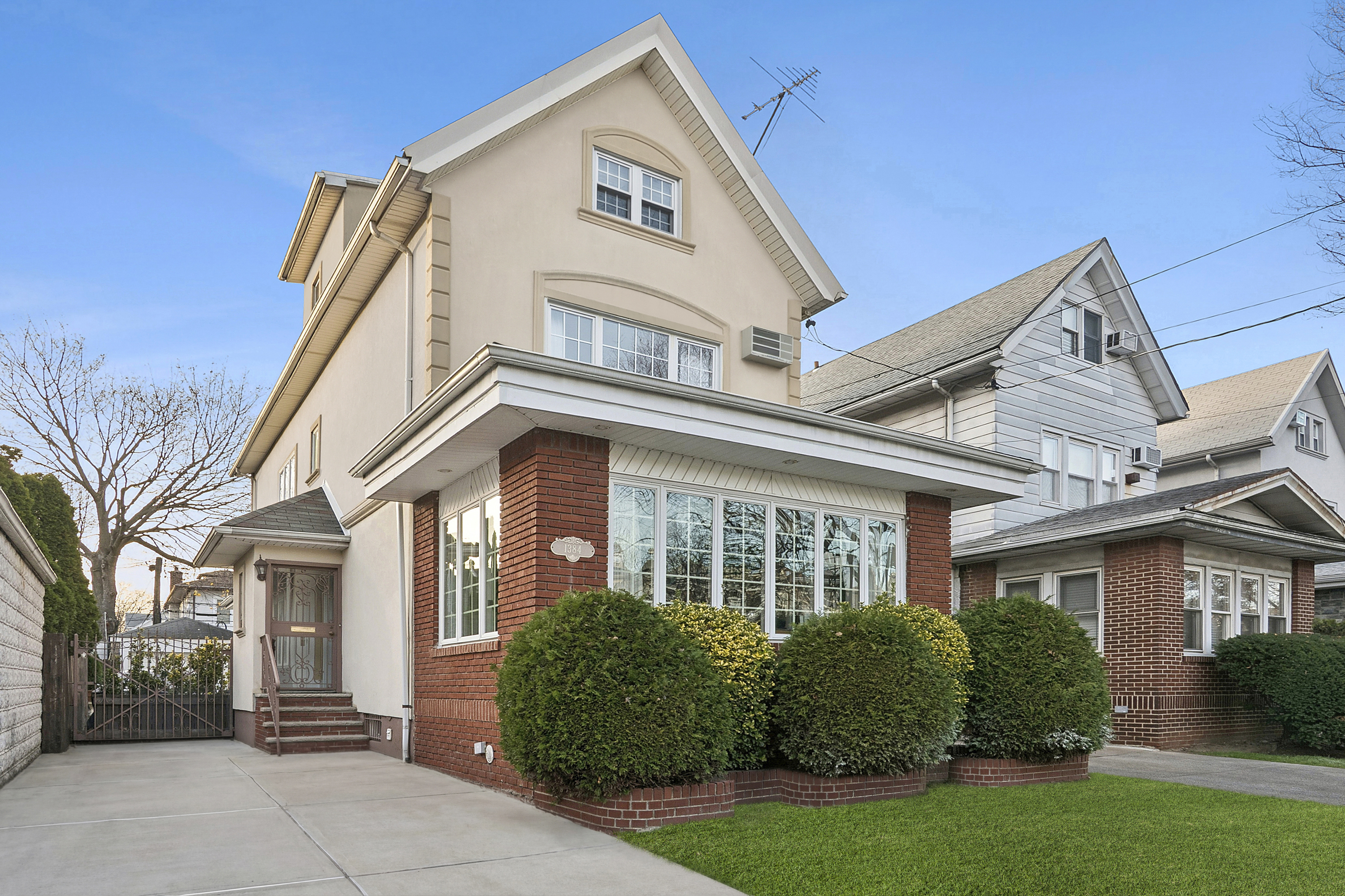 1384 East 29th Street Brooklyn, NY 11210 - Photo 1 of 21 a front view of a house with a garden