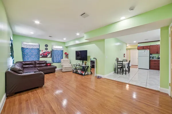 a living room with furniture and a wooden floor