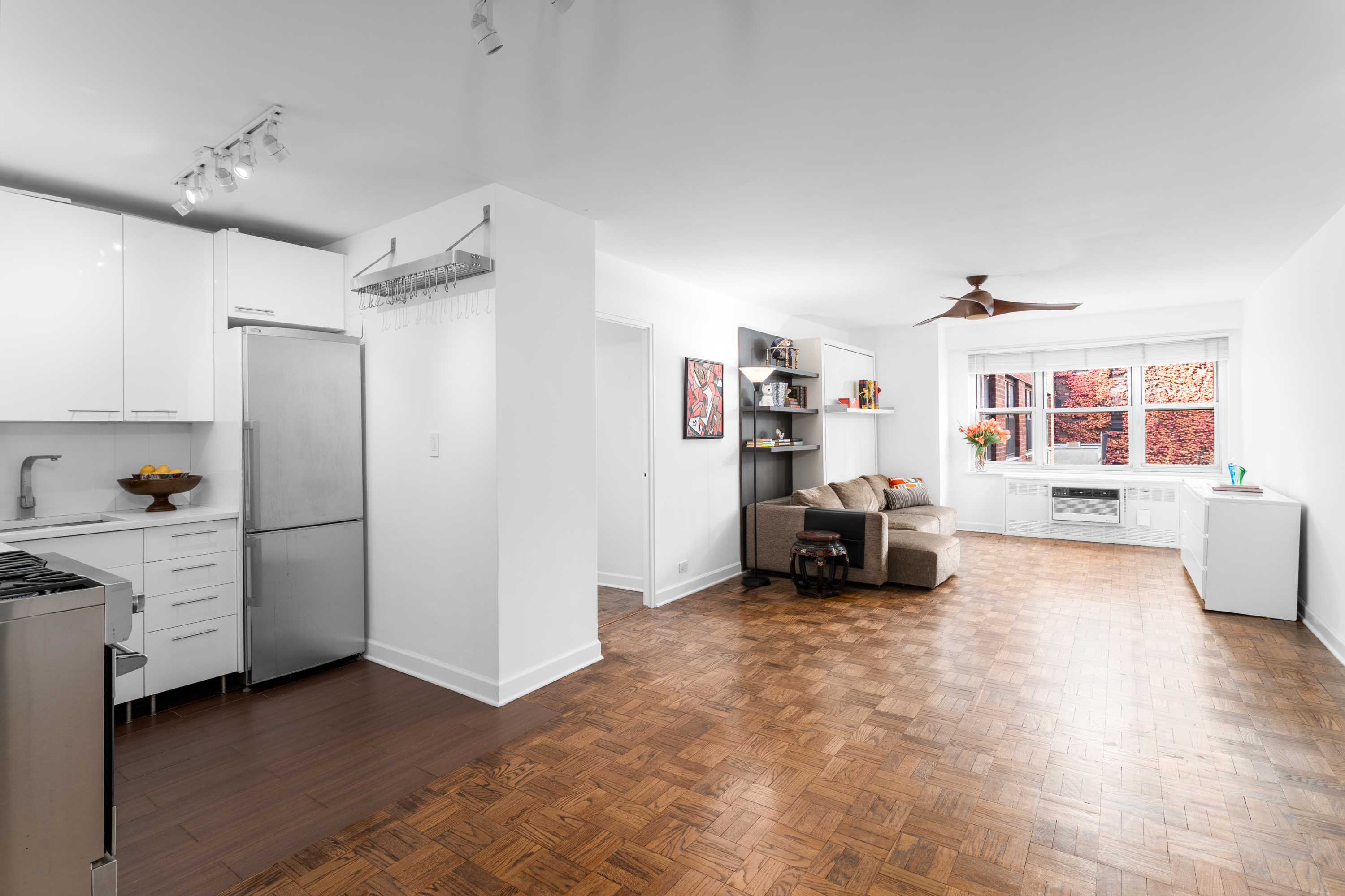 251 East 51st Street, Unit 5A Manhattan, NY 10022 - Photo 2 of 23 a living room with furniture and a flat screen tv