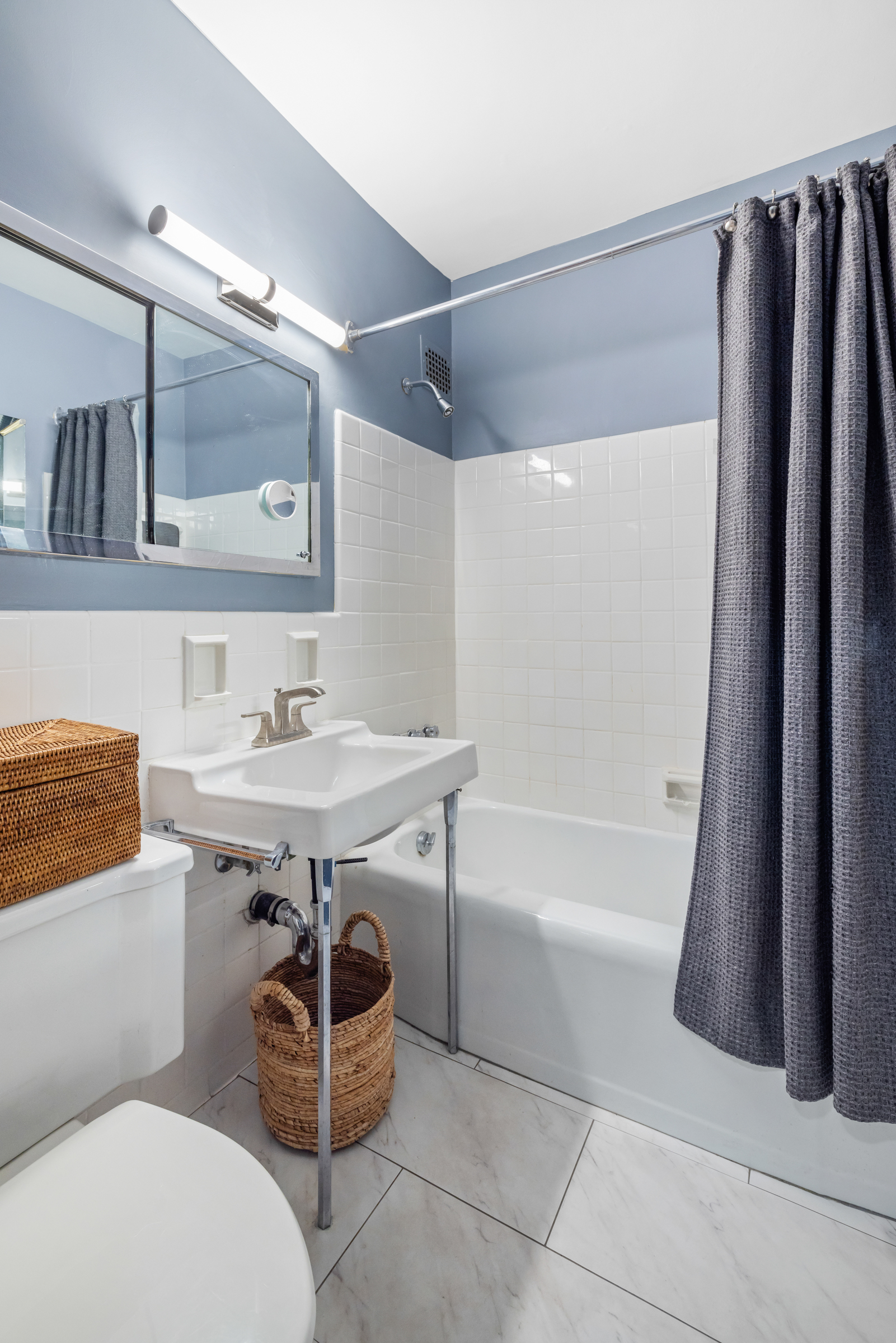 16 Sutton Place, Unit 11A Manhattan, NY 10022 - Photo 8 of 19 a bathroom with a sink double vanity and a bathtub