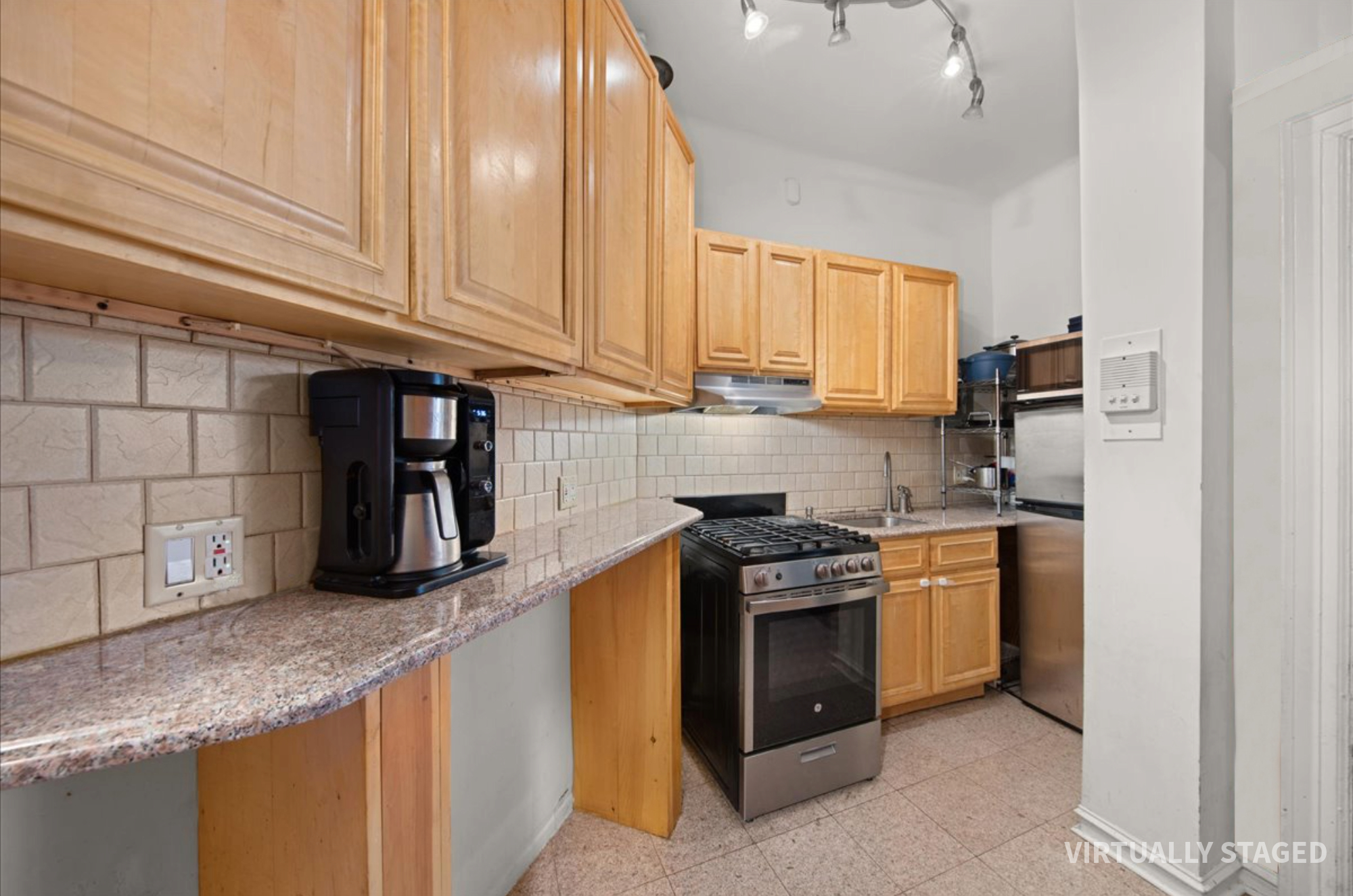 2 Marine Avenue, Unit 1B Brooklyn, NY 11209 - Photo 6 of 14 a kitchen with granite countertop a stove sink and cabinets