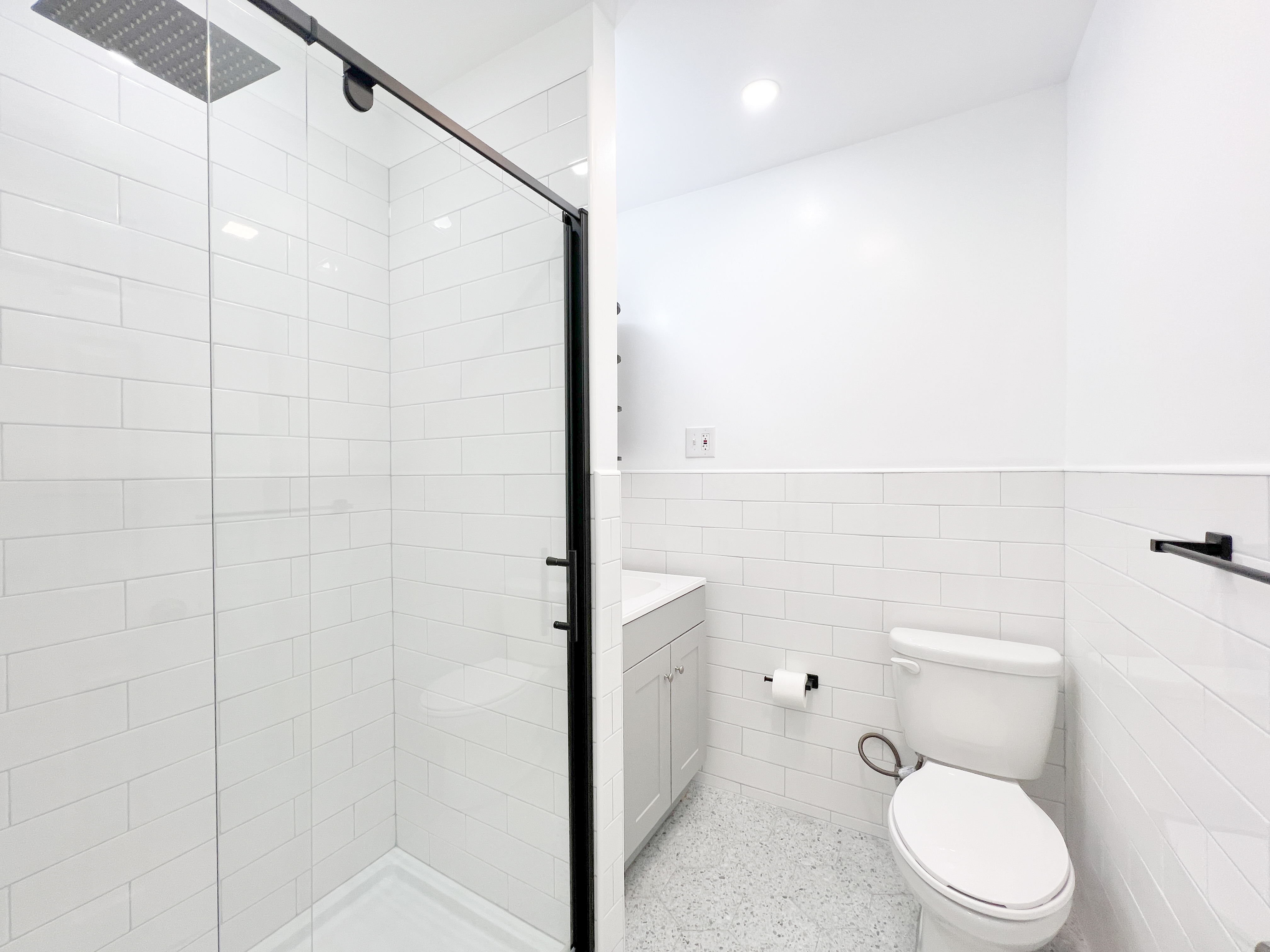 556 Vanderbilt Avenue, Unit 2 Brooklyn, NY 11238 - Photo 7 of 14 a white toilet sitting next to a bathroom sink